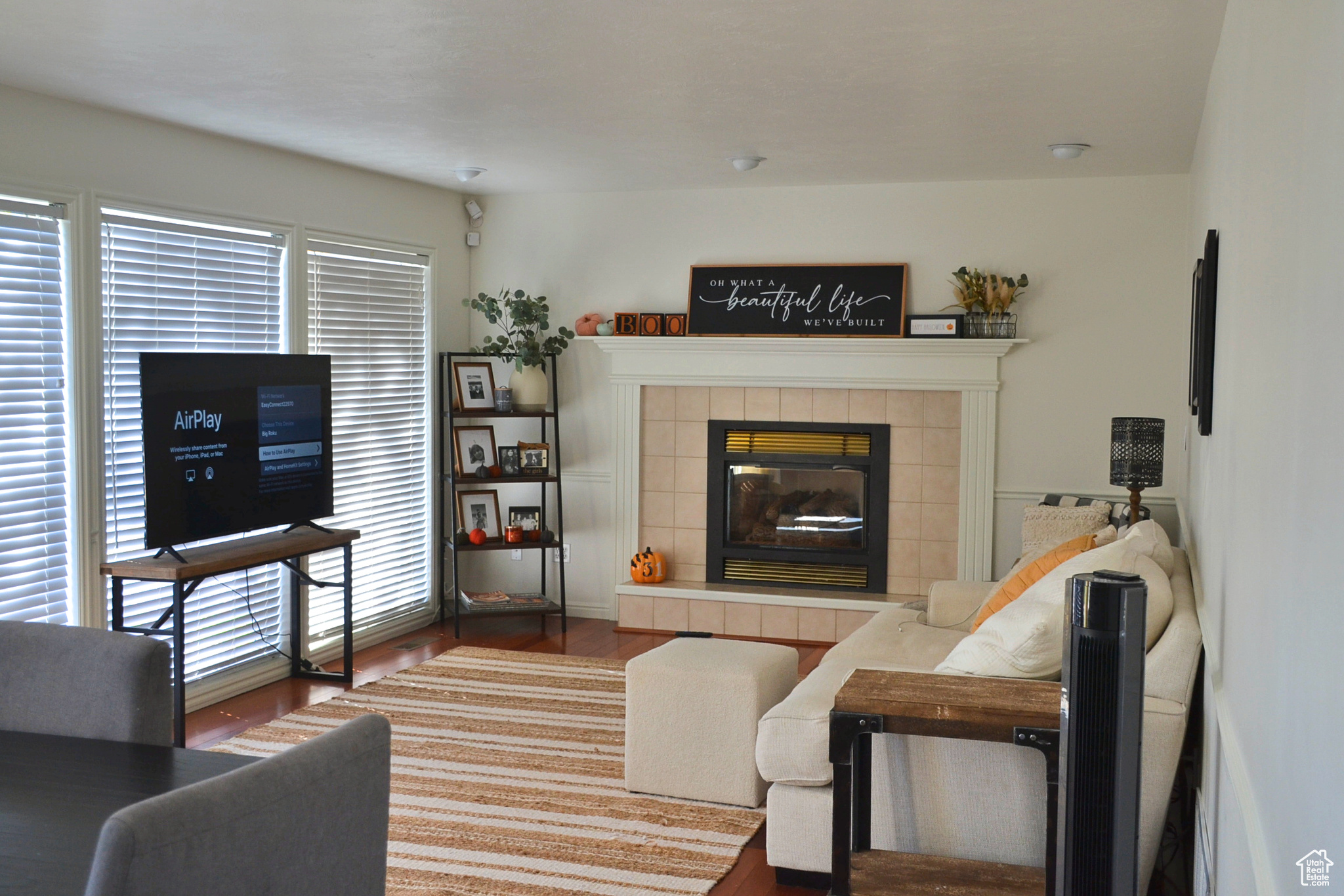 Living room featuring dark hardwood / wood-style floors and a tile fireplace