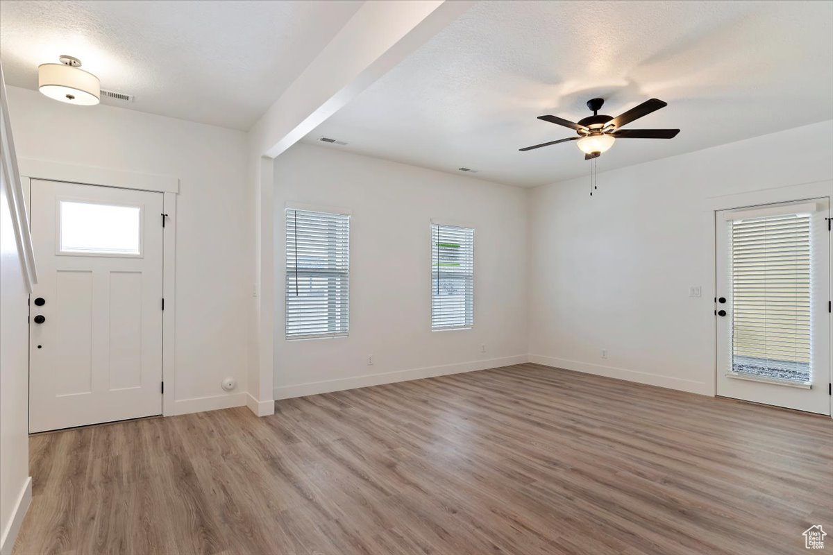 Entryway featuring light hardwood / wood-style floors, beamed ceiling, and ceiling fan