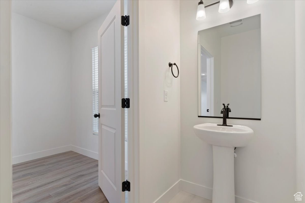 Bathroom with sink and hardwood / wood-style flooring