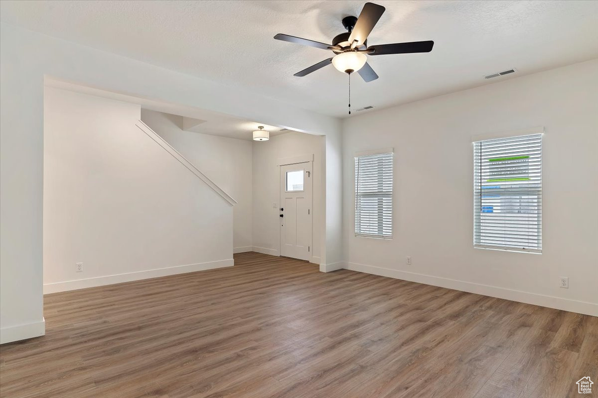 Spare room with light hardwood / wood-style flooring and ceiling fan