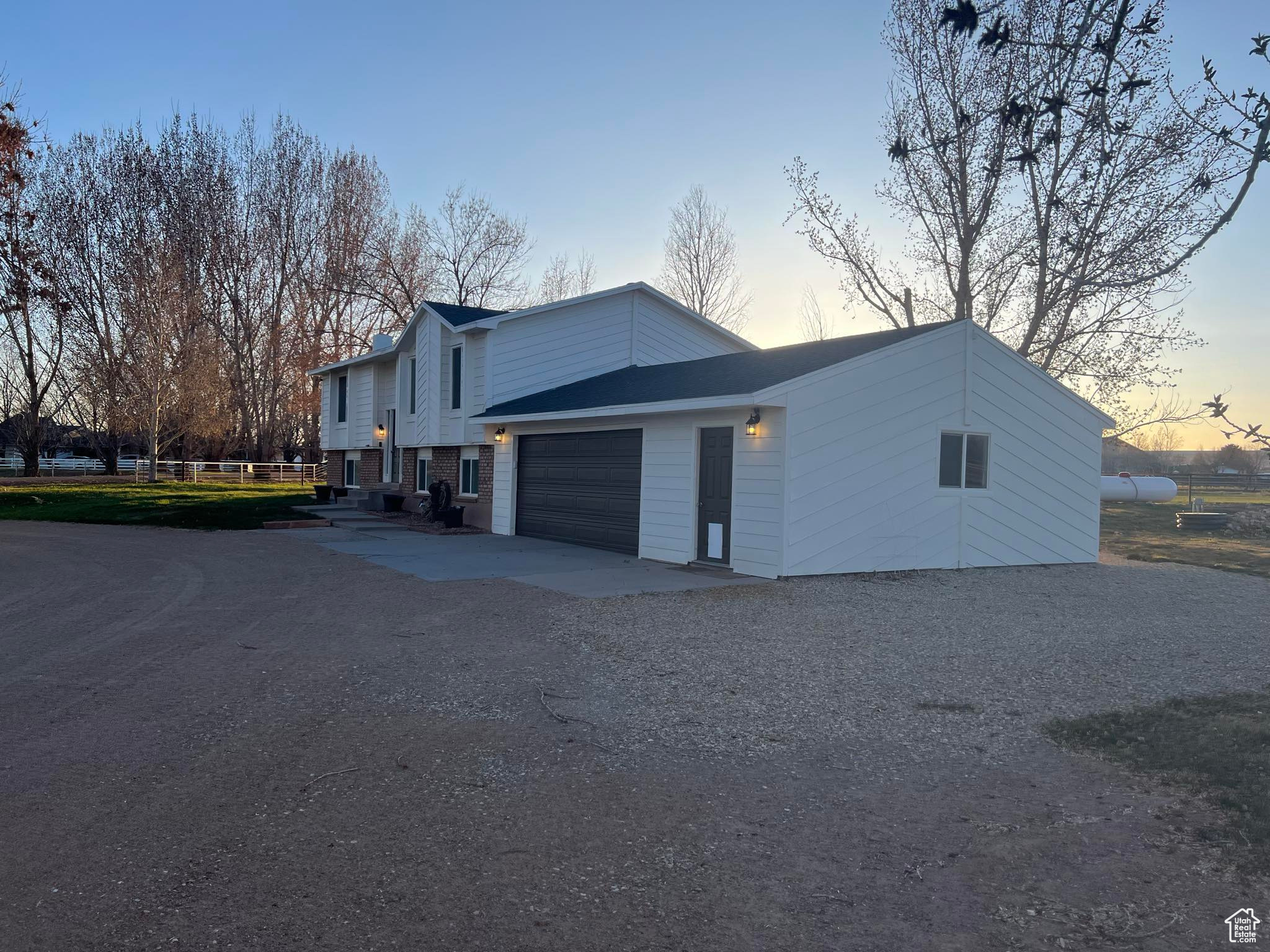 Property exterior at dusk with a garage