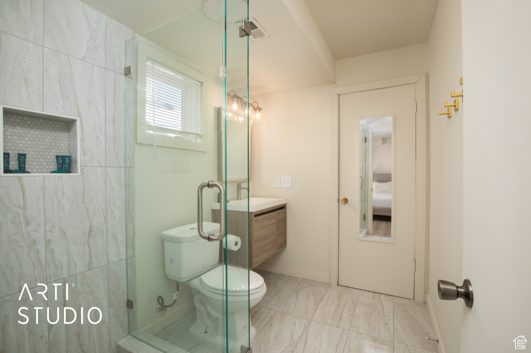 Bathroom featuring vanity, toilet, walk in shower, and tile floors