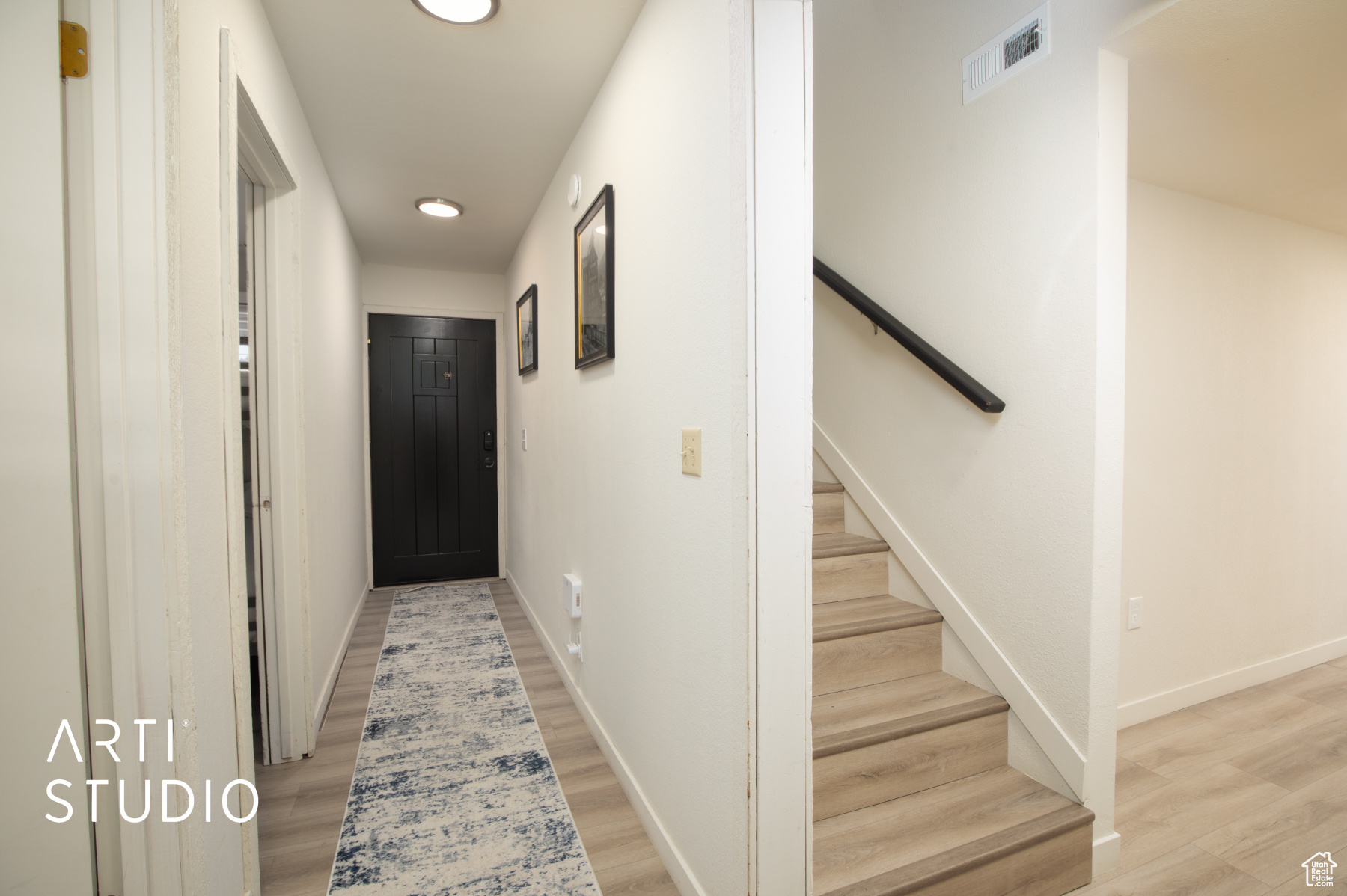 Entry corridor featuring light wood-style floors