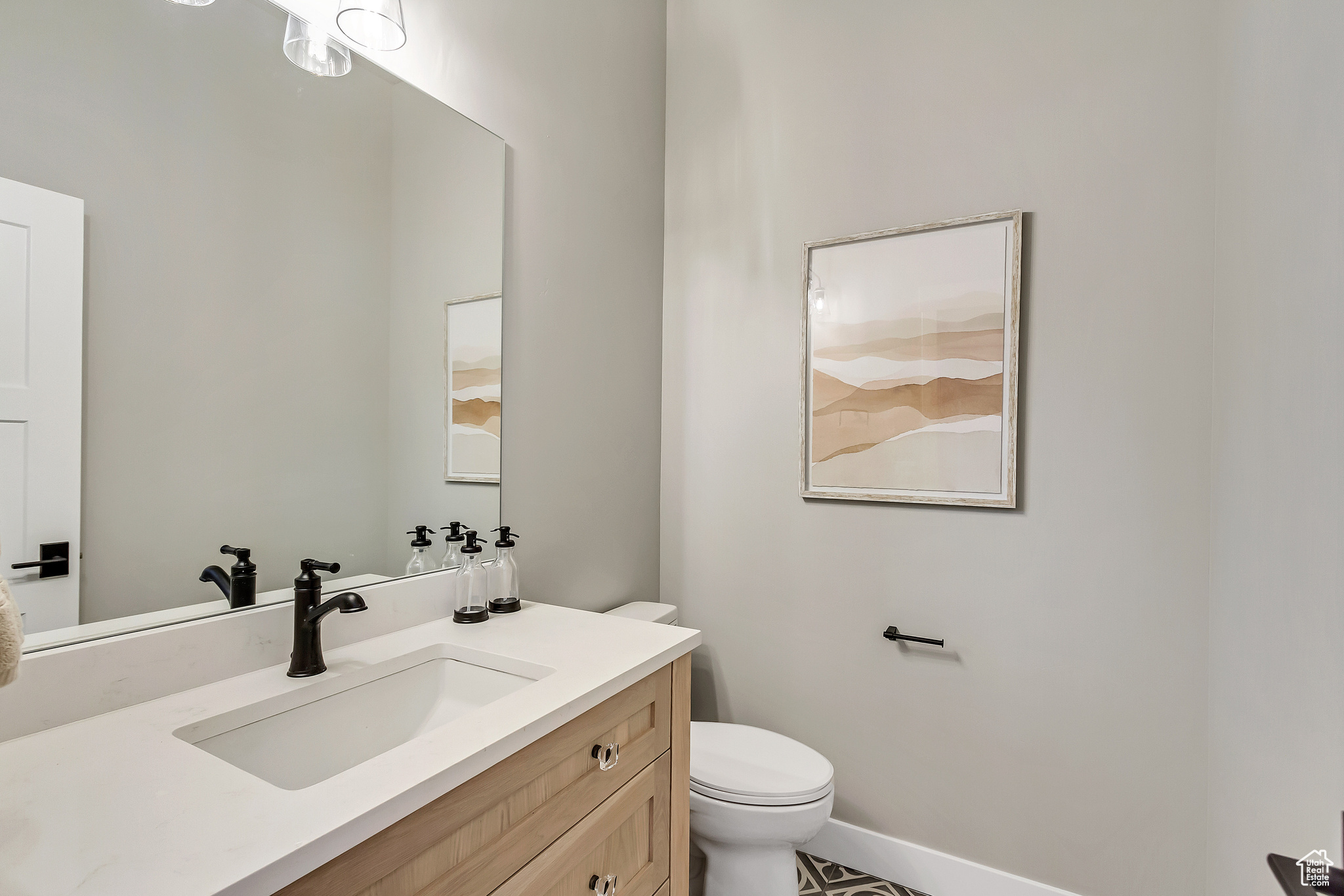Bathroom featuring tile floors, toilet, and vanity
