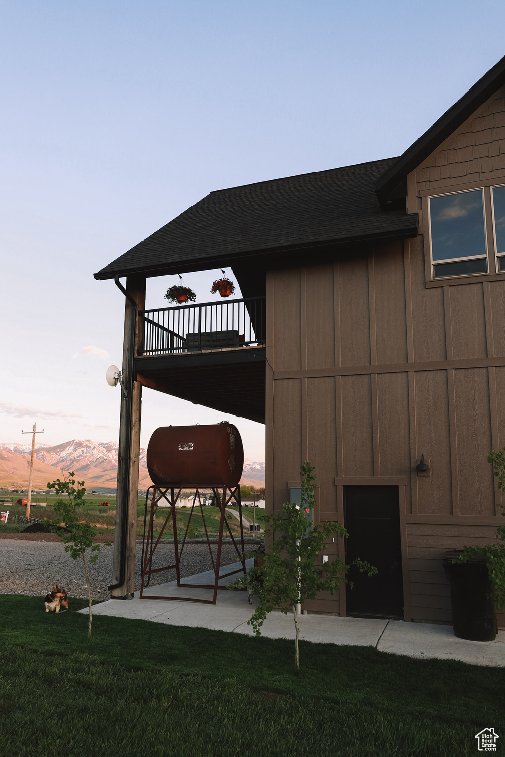 Exterior space with a patio area, a mountain view, and a yard.