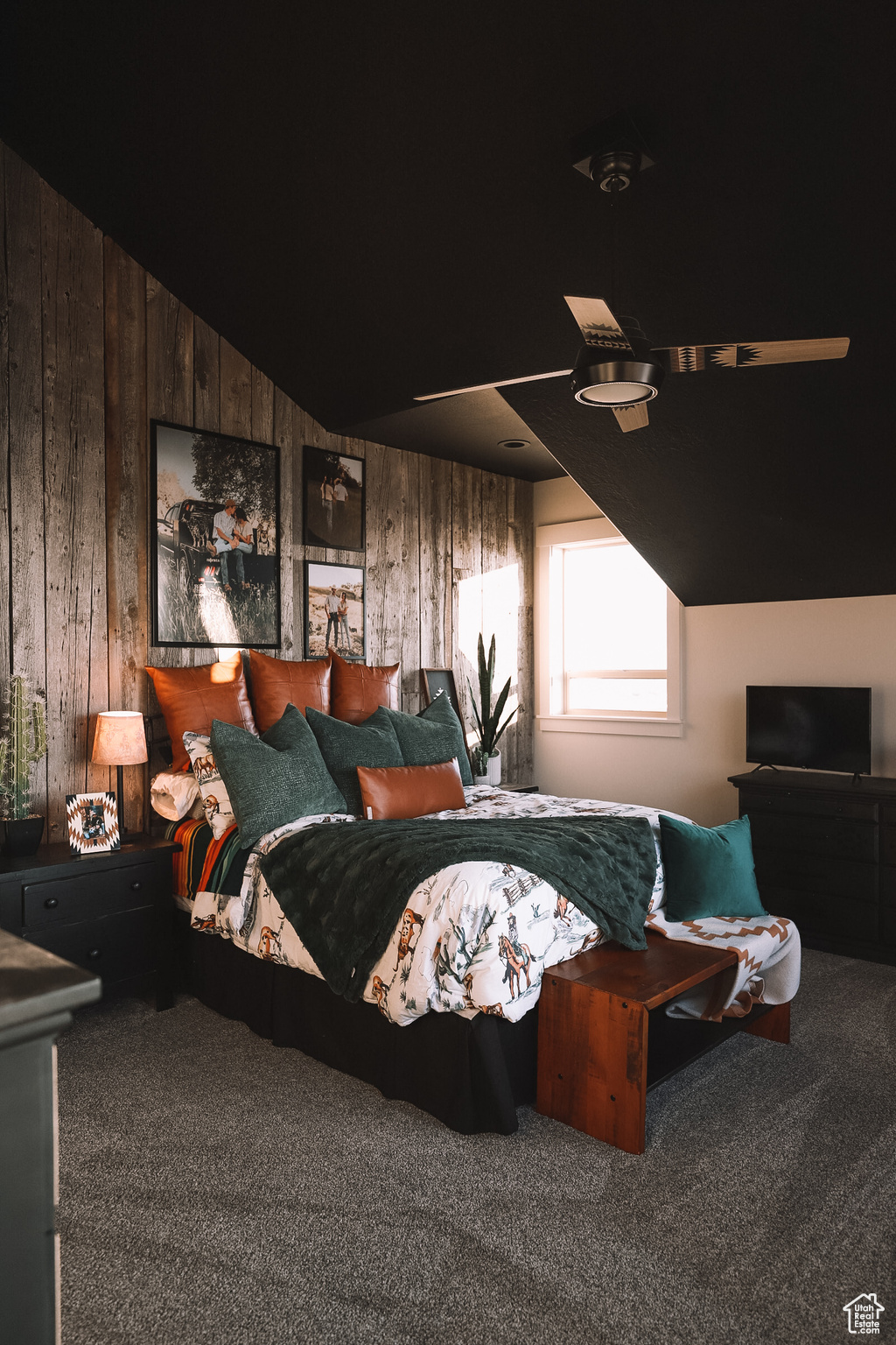 Bedroom featuring wooden walls, carpet floors, and lofted ceiling