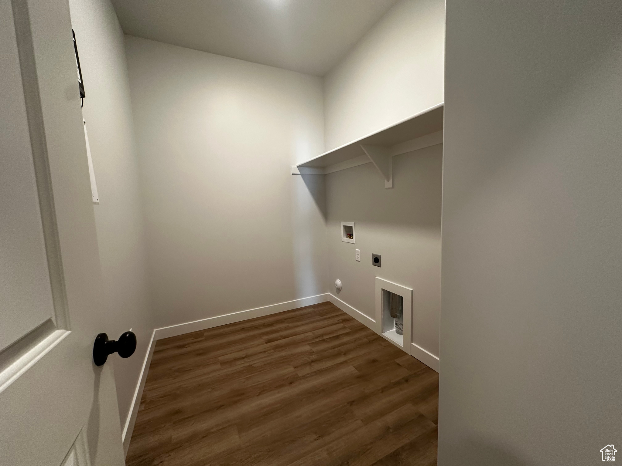 Washroom with dark hardwood / wood-style flooring, hookup for a washing machine, gas dryer hookup, and hookup for an electric dryer