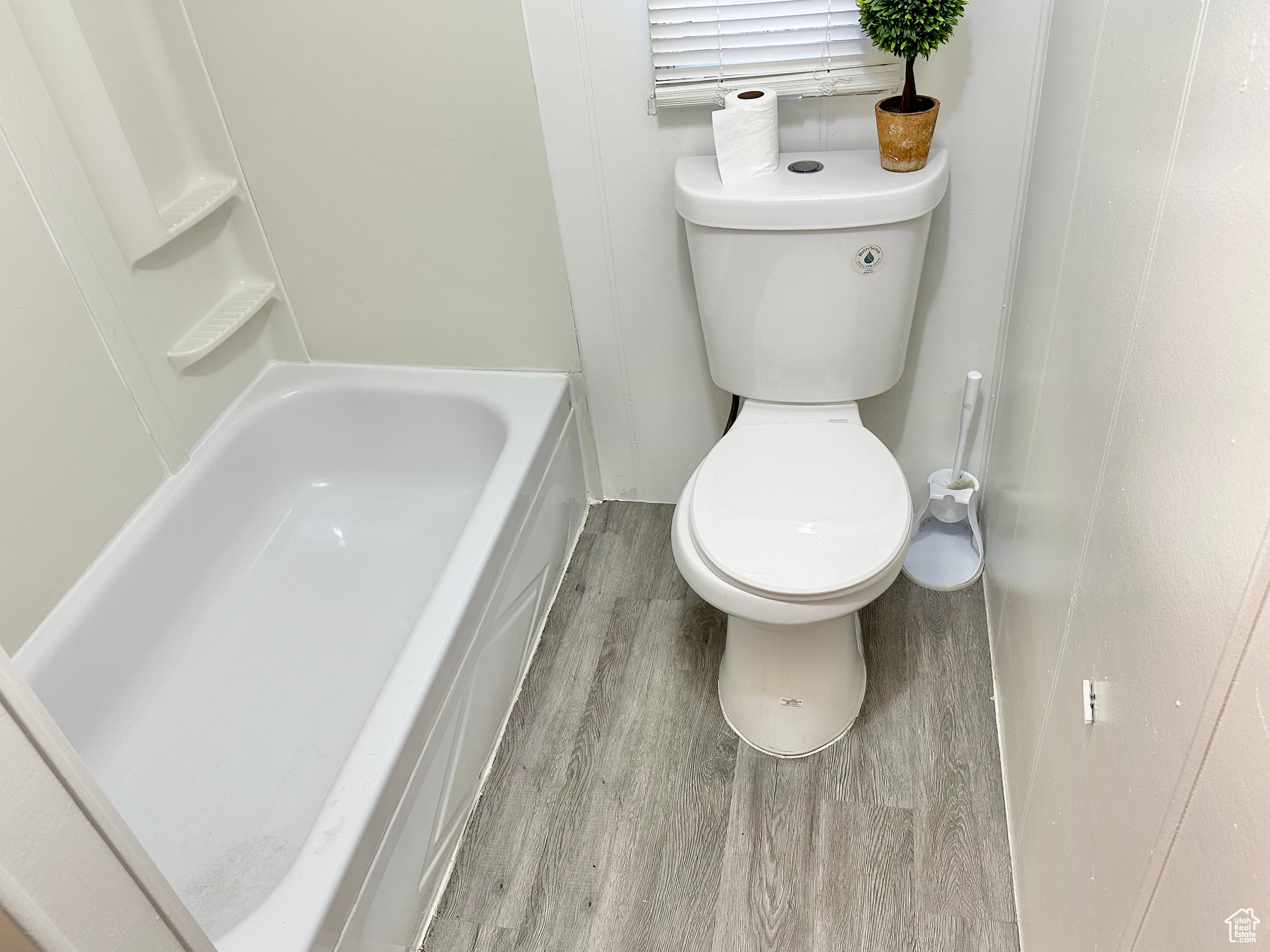 Bathroom featuring hardwood / wood-style floors and toilet