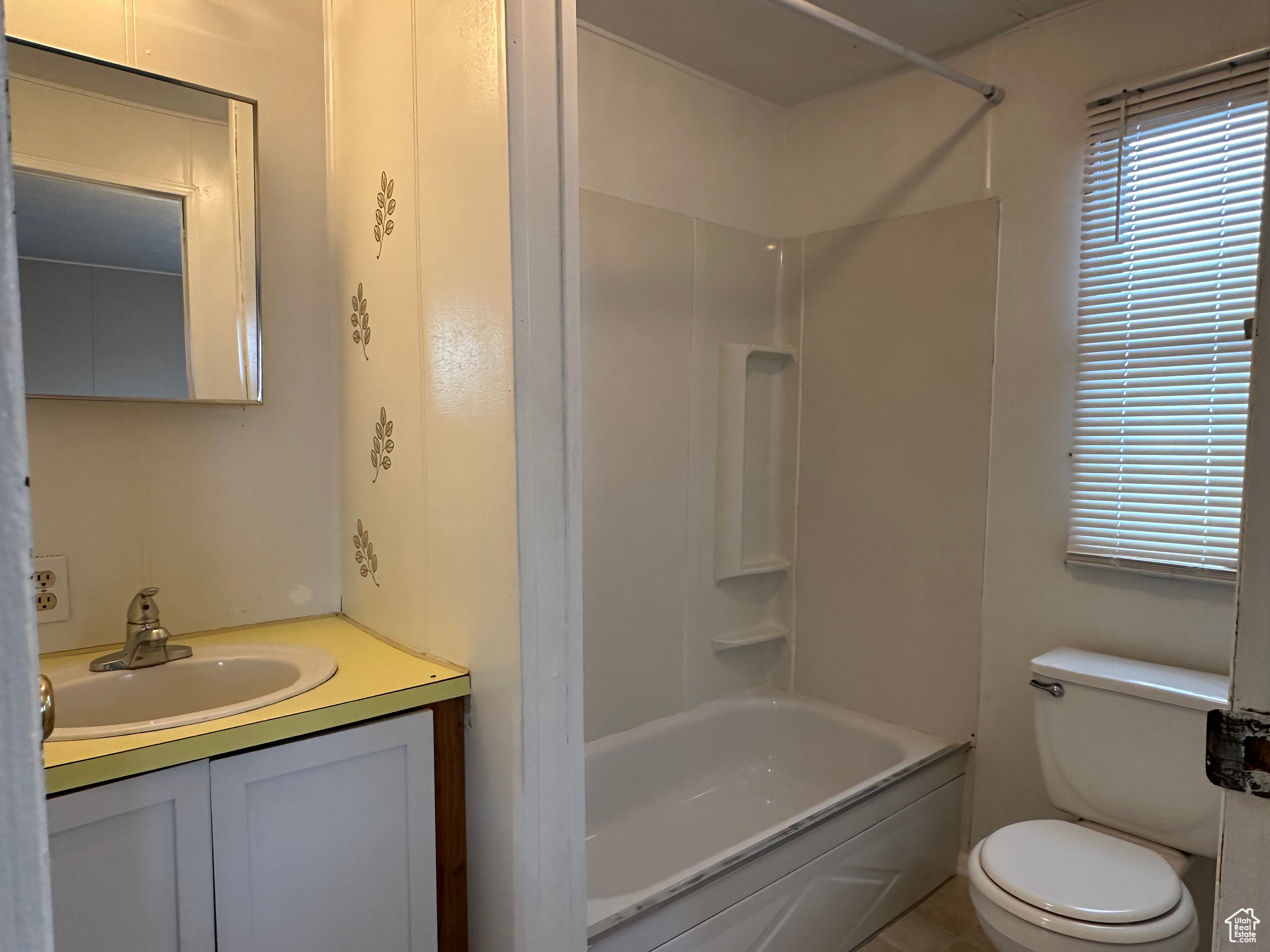 Full bathroom featuring vanity, toilet, and tub / shower combination