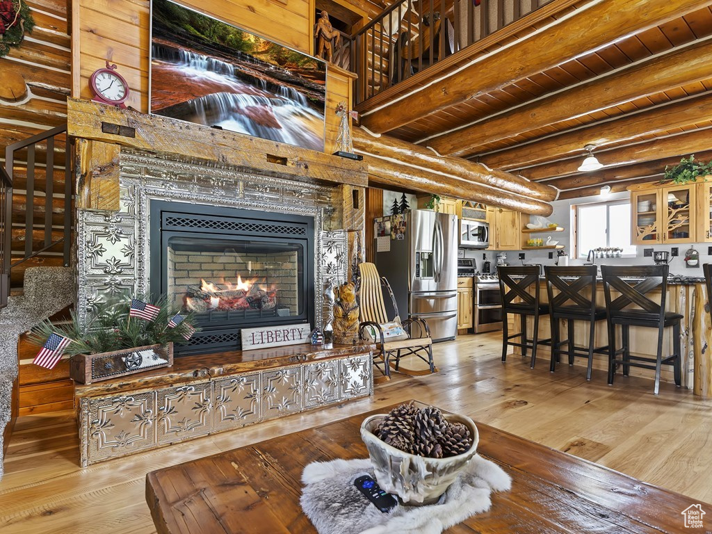 Living room with light wood-type flooring and beam ceiling