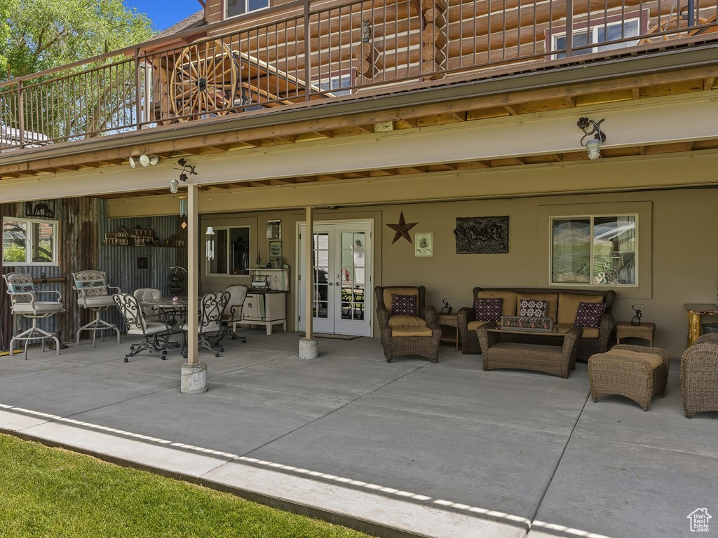 View of patio / terrace with french doors, outdoor lounge area, and a balcony