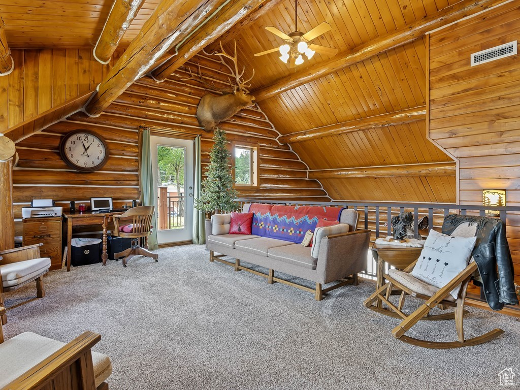 Living room featuring rustic walls, ceiling fan, carpet flooring, and wood ceiling