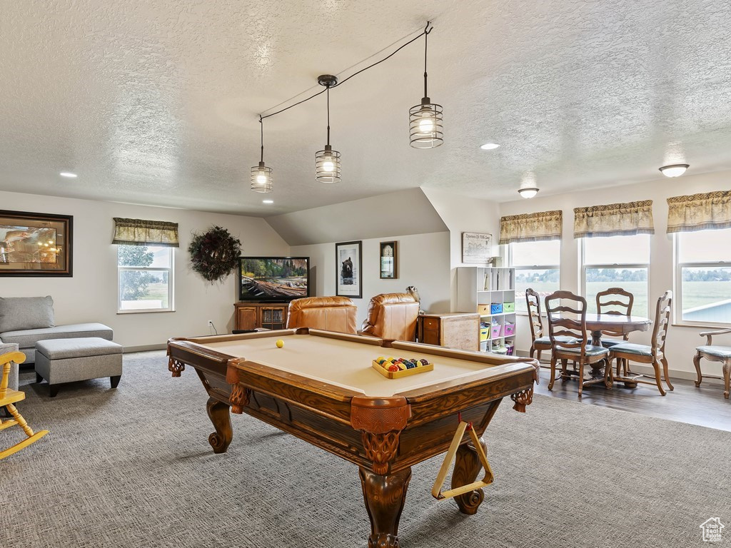 Rec room with lofted ceiling, carpet flooring, billiards, and a textured ceiling