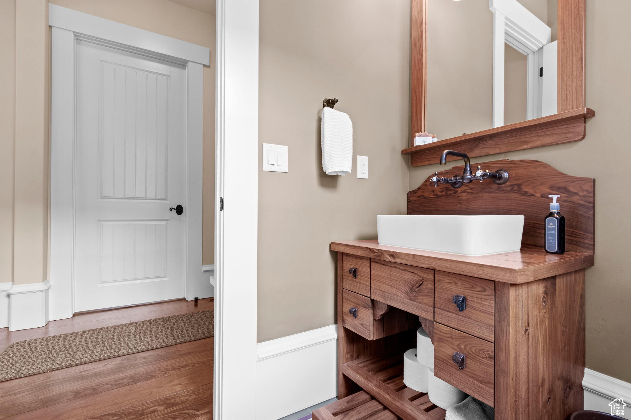 Bathroom with oversized vanity and hardwood / wood-style flooring