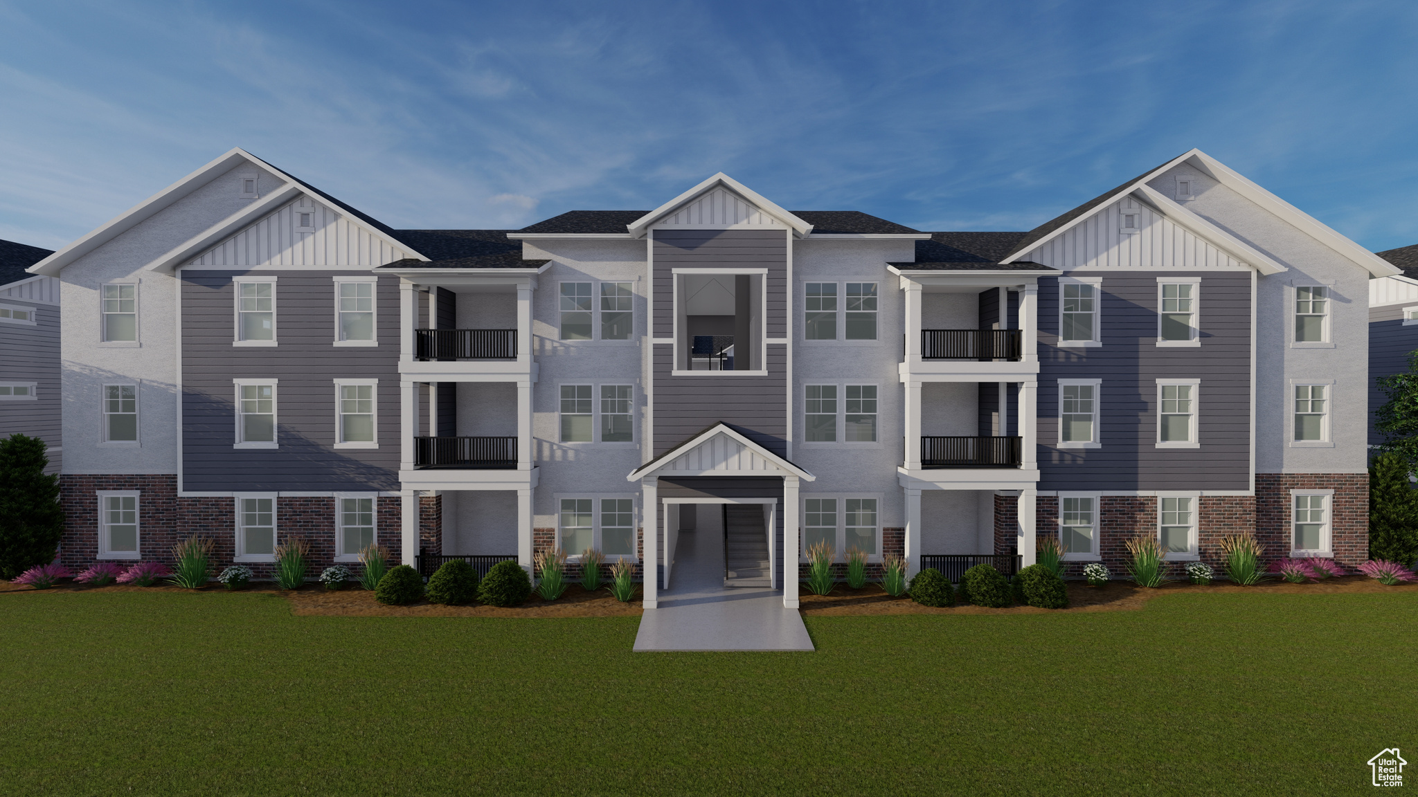 Townhome / multi-family property with a front lawn and a balcony