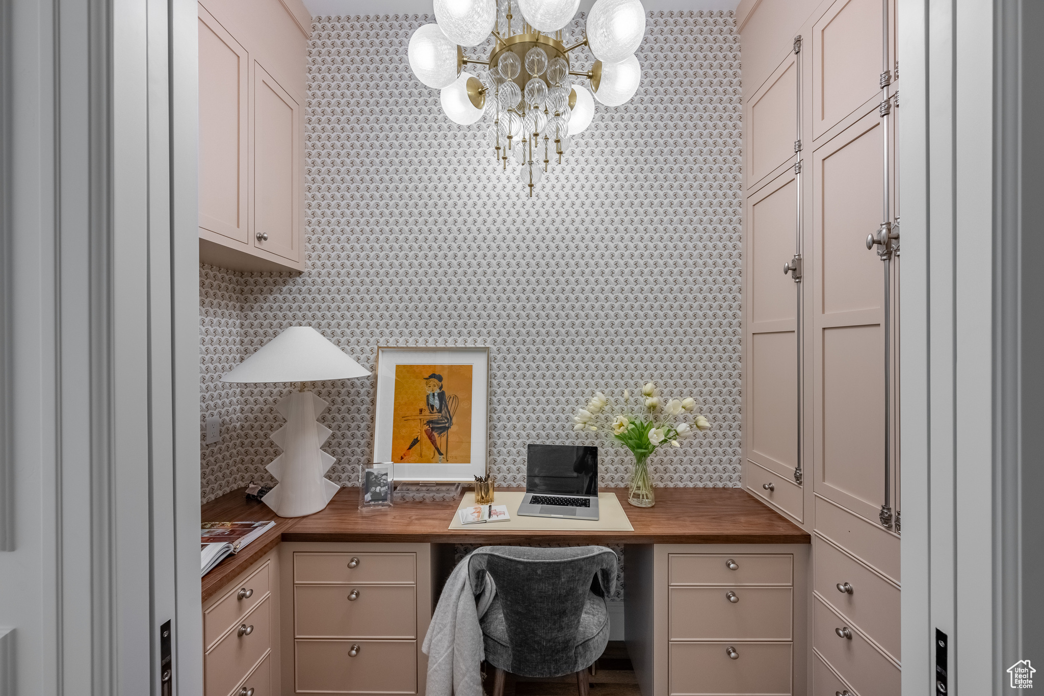 Home office featuring a chandelier and built in desk
