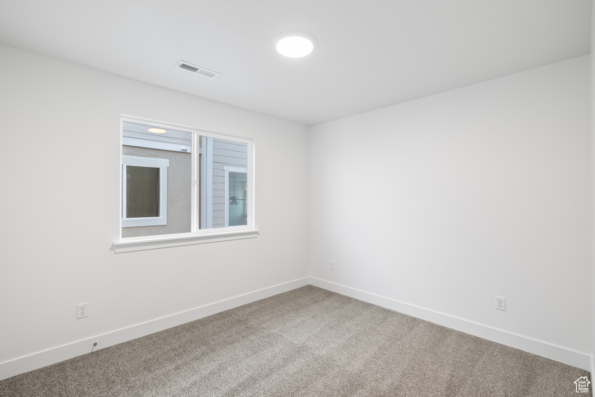 Empty room featuring carpet flooring