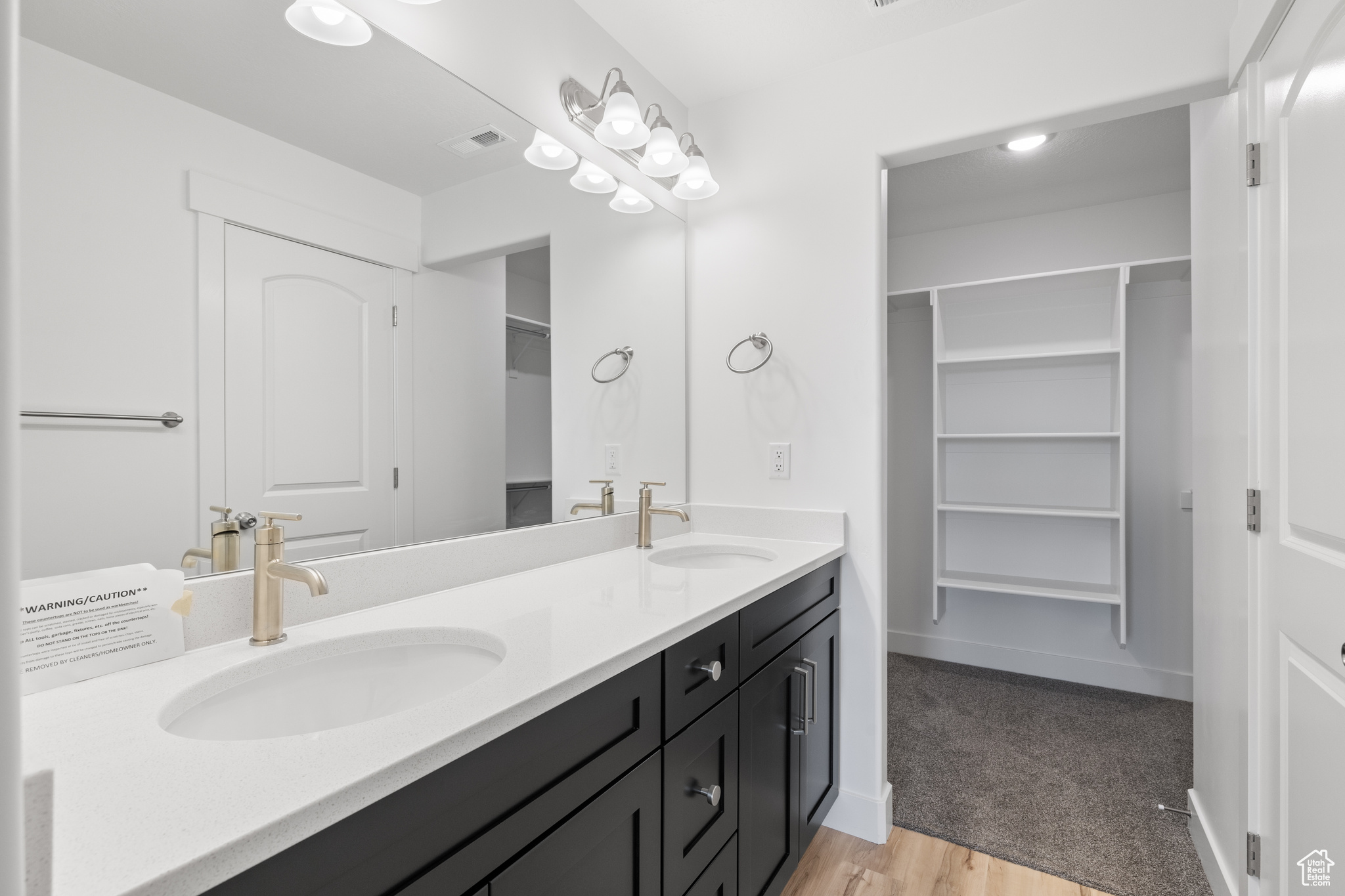 Bathroom featuring hardwood / wood-style flooring and double sink vanity