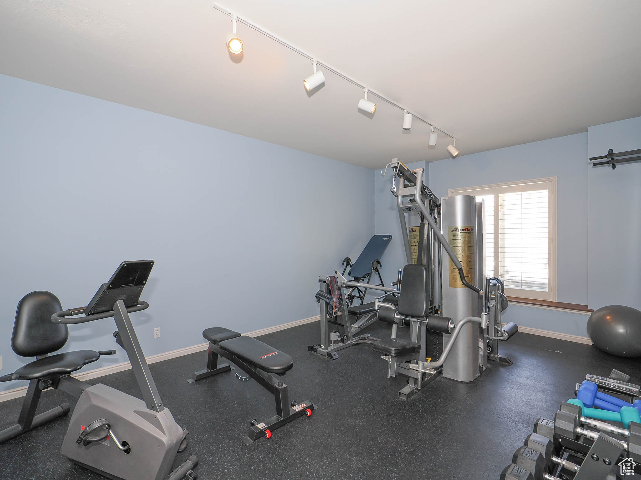 Lower-level workout room with rubber floor and Jack-and Jill bathroom shared with Basement Bathroom .
