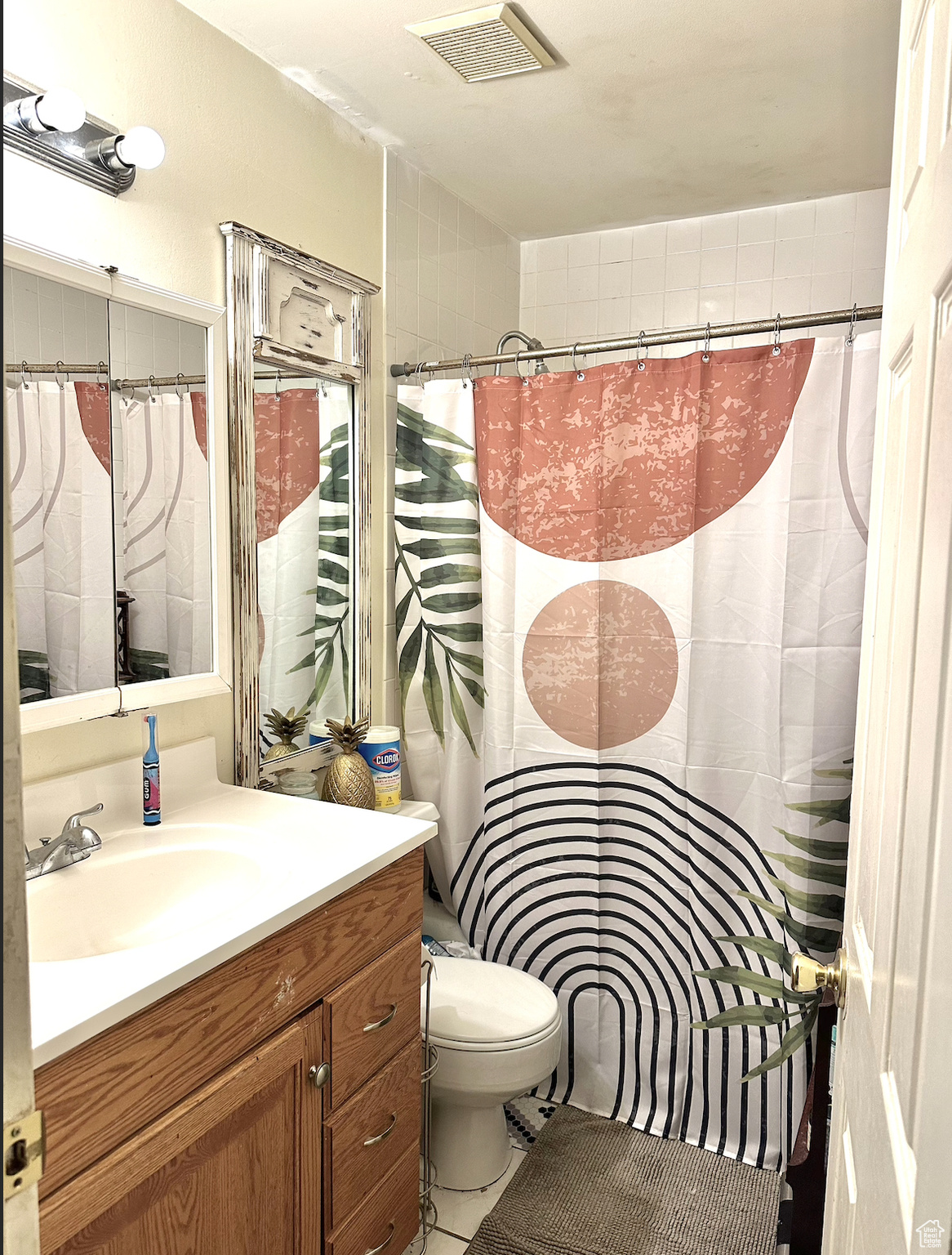 Bathroom with toilet, tile flooring, and oversized vanity