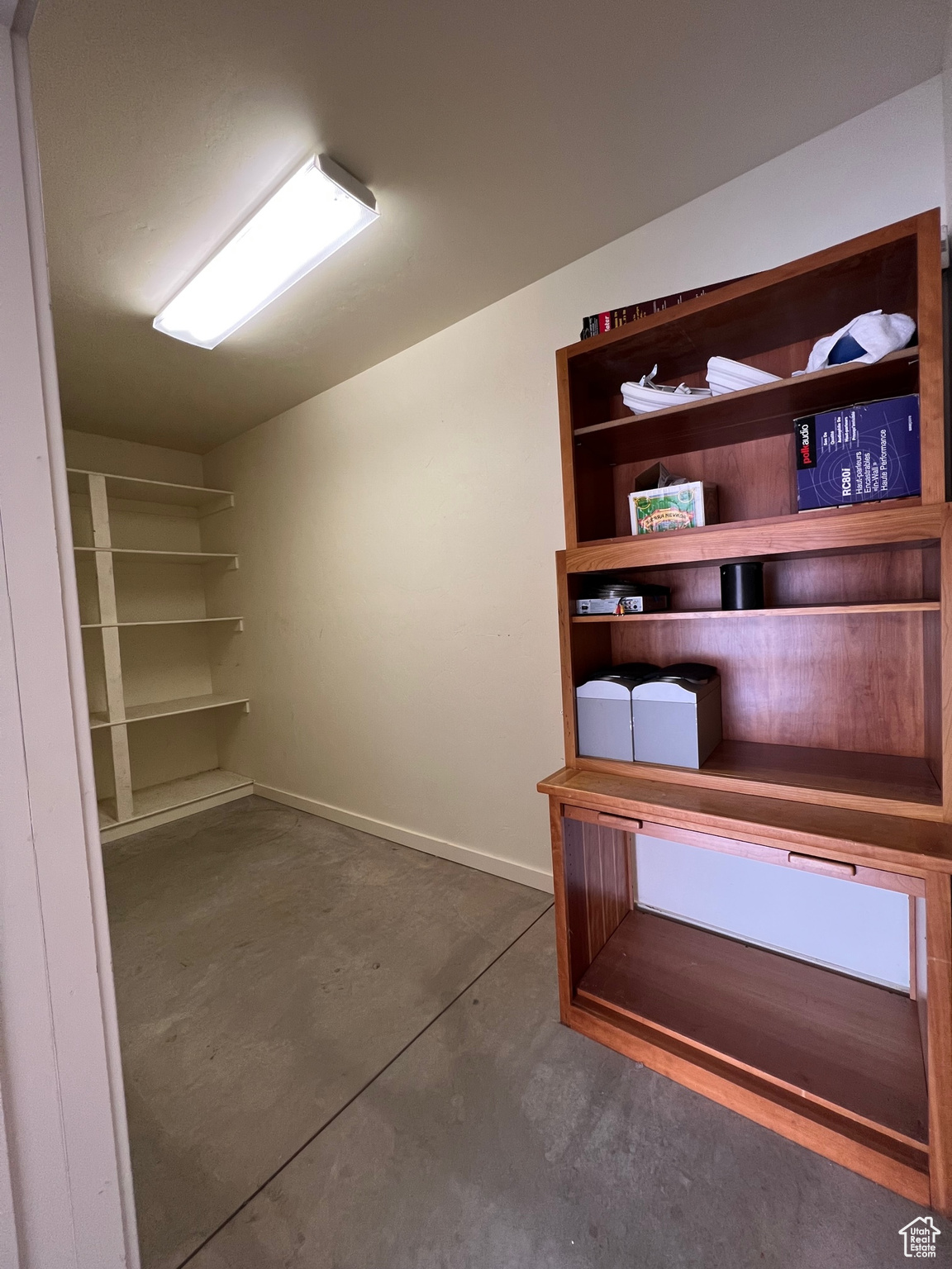 Giant owner closet in garage.  Clean shelves and extra storage.