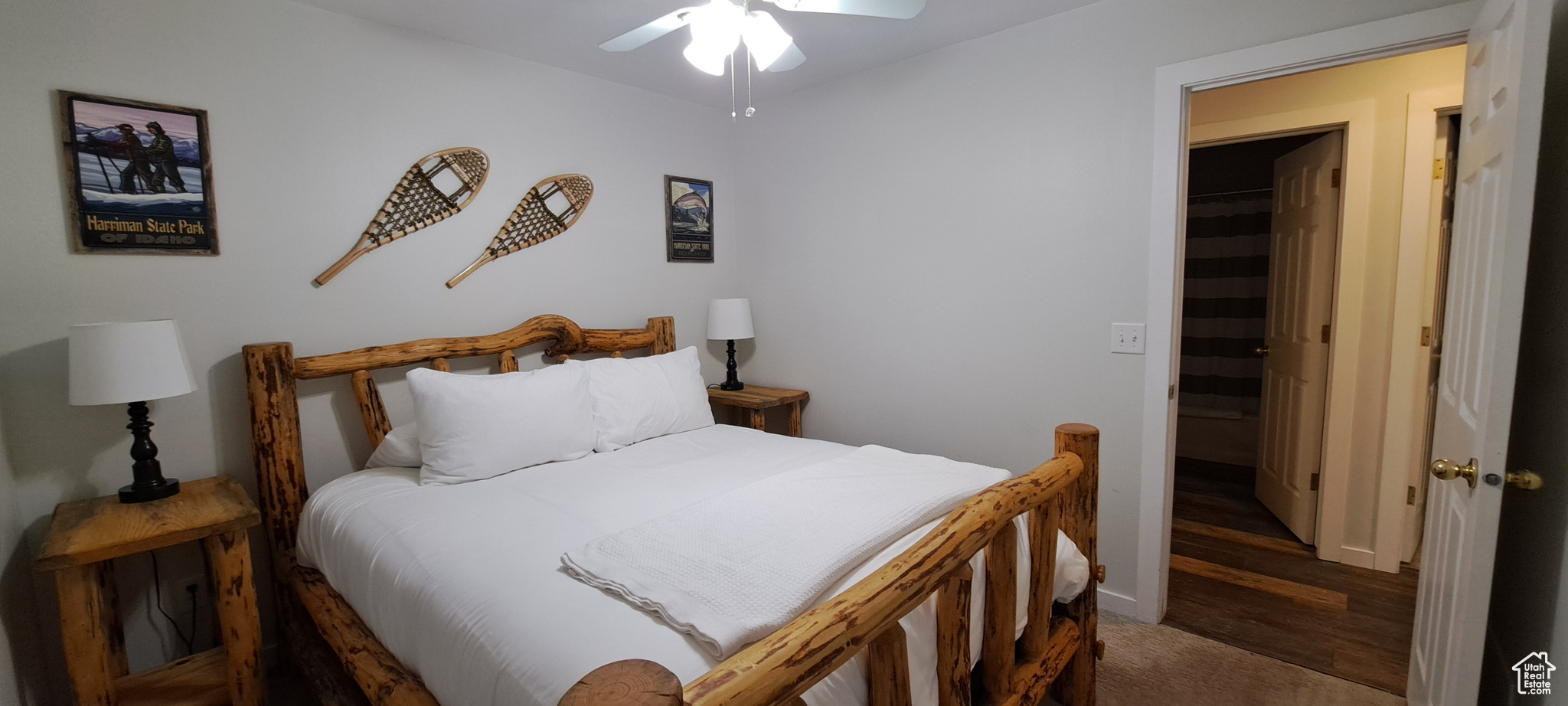 Bedroom featuring ensuite bathroom, a spacious closet, dark hardwood / wood-style floors, and ceiling fan