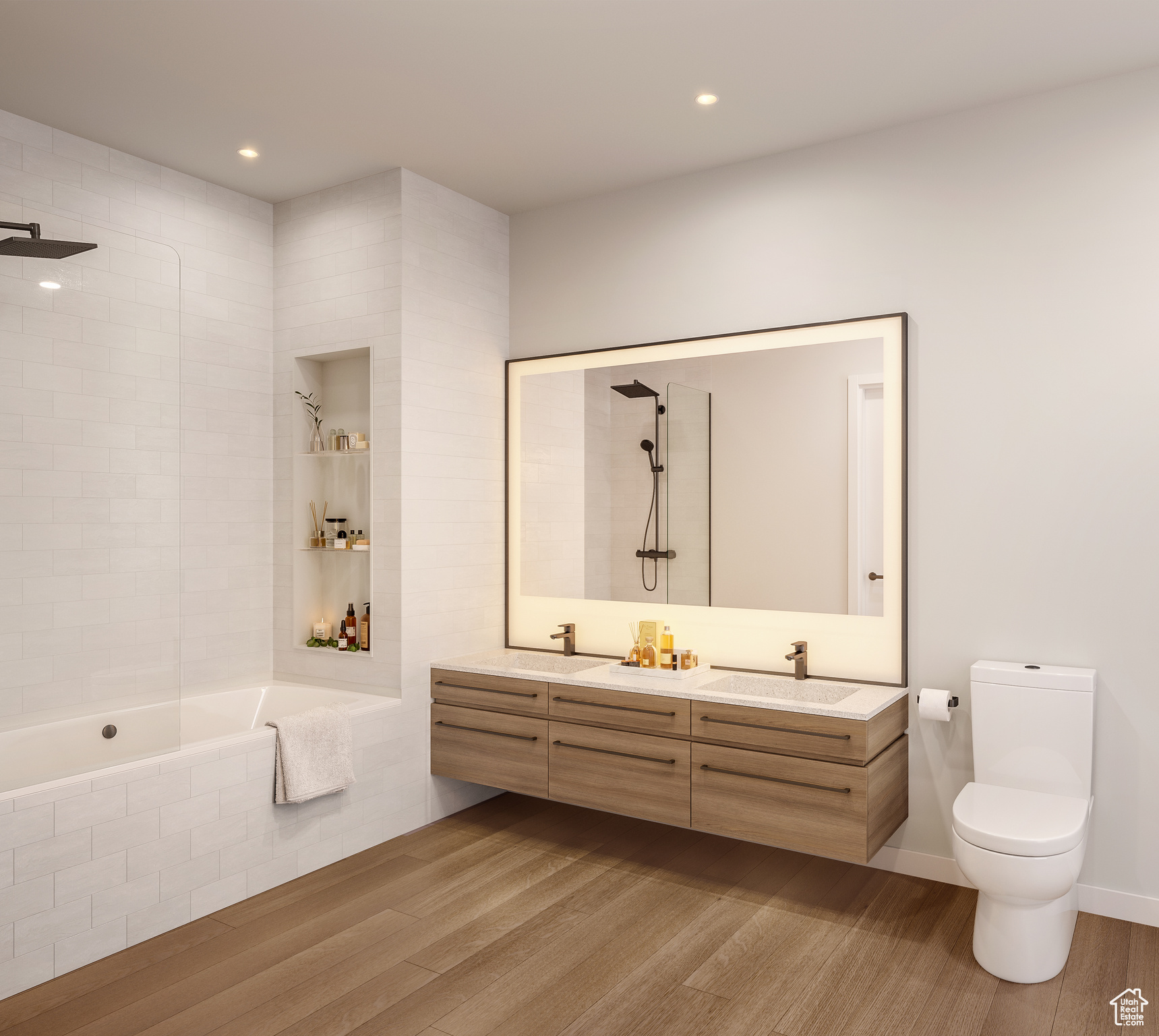 Full bathroom with toilet, dual sinks, large vanity, wood-type flooring, and tiled shower / bath