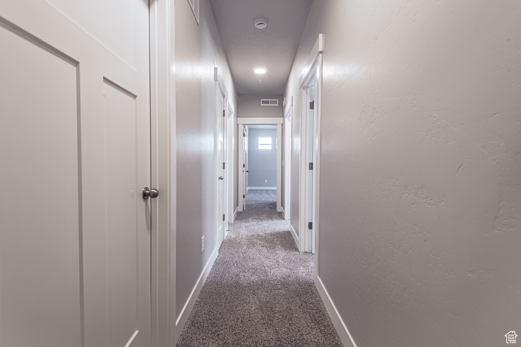 Hallway featuring carpet floors