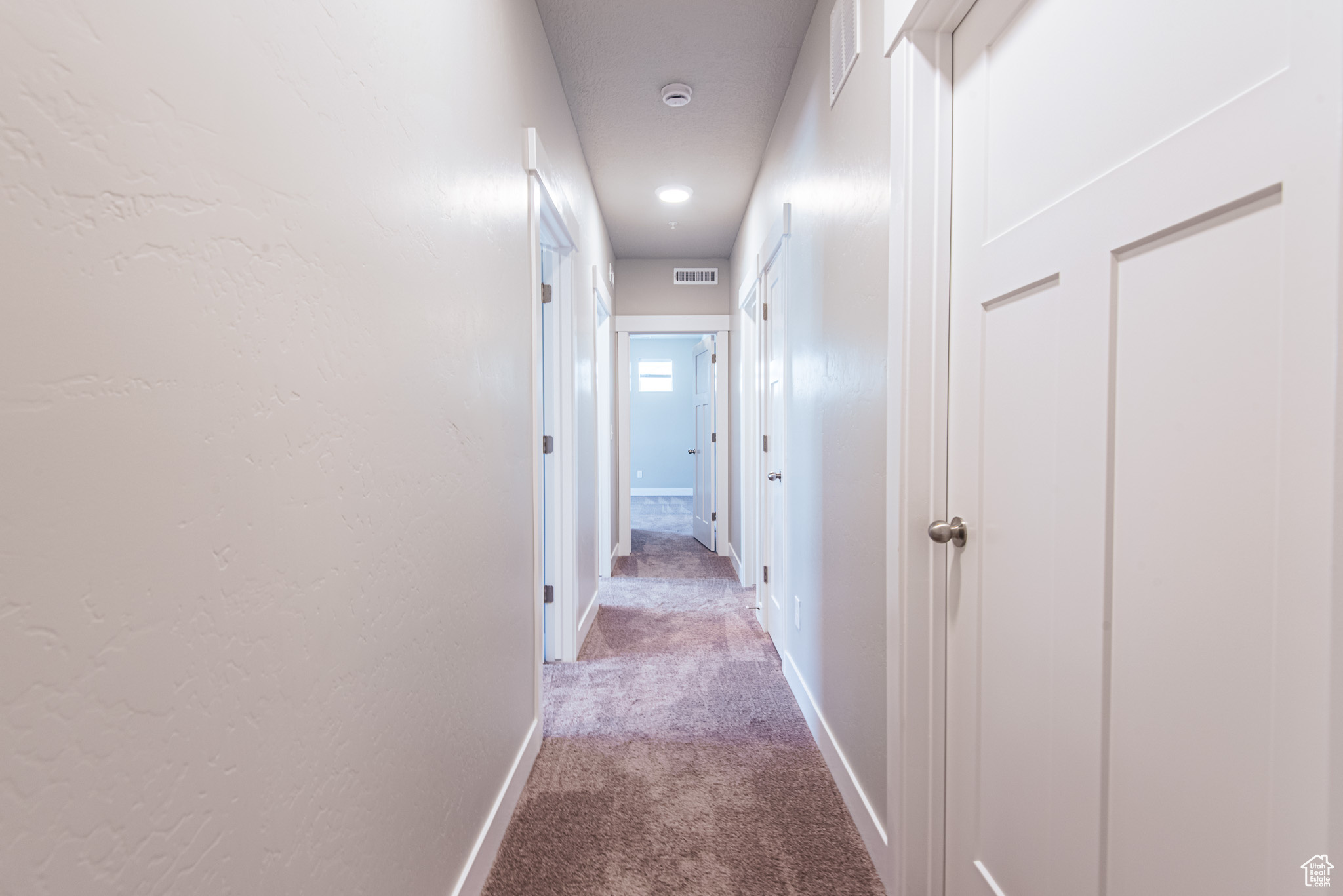 Hallway featuring carpet floors