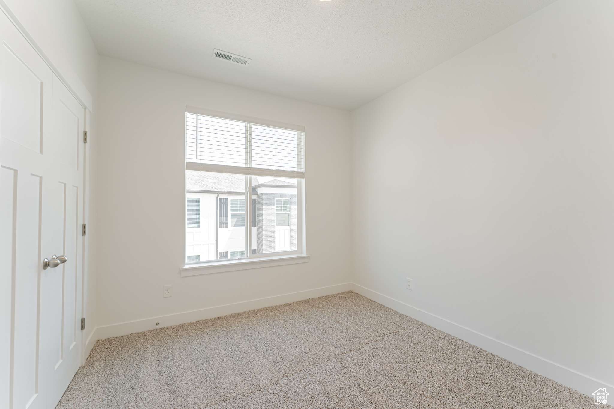 Interior space featuring light colored carpet