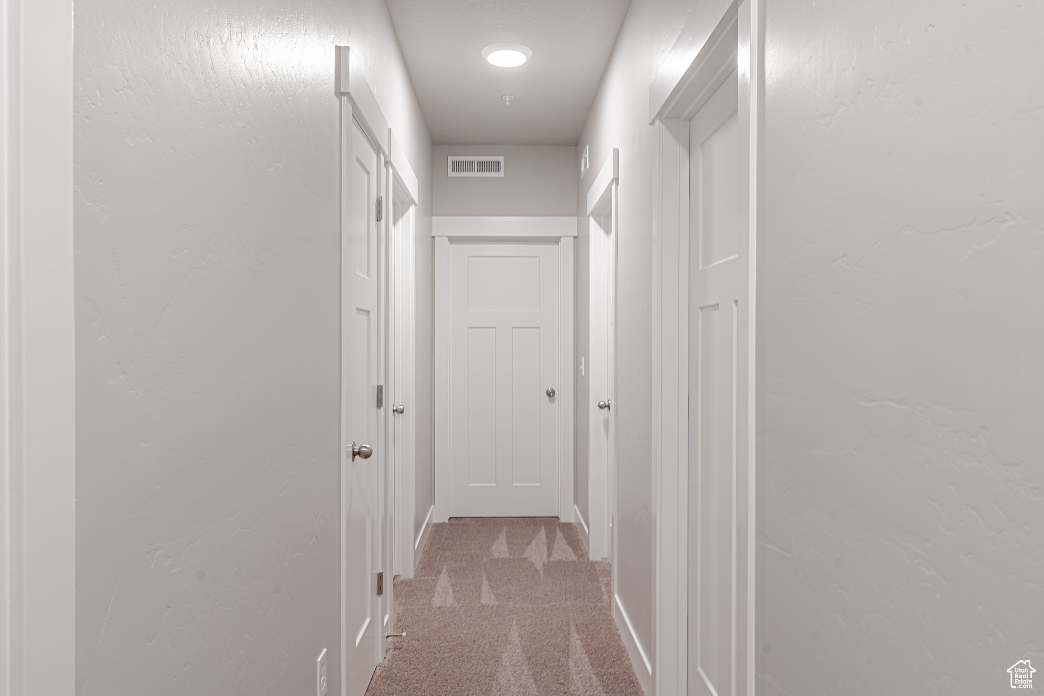 Hallway with carpet flooring