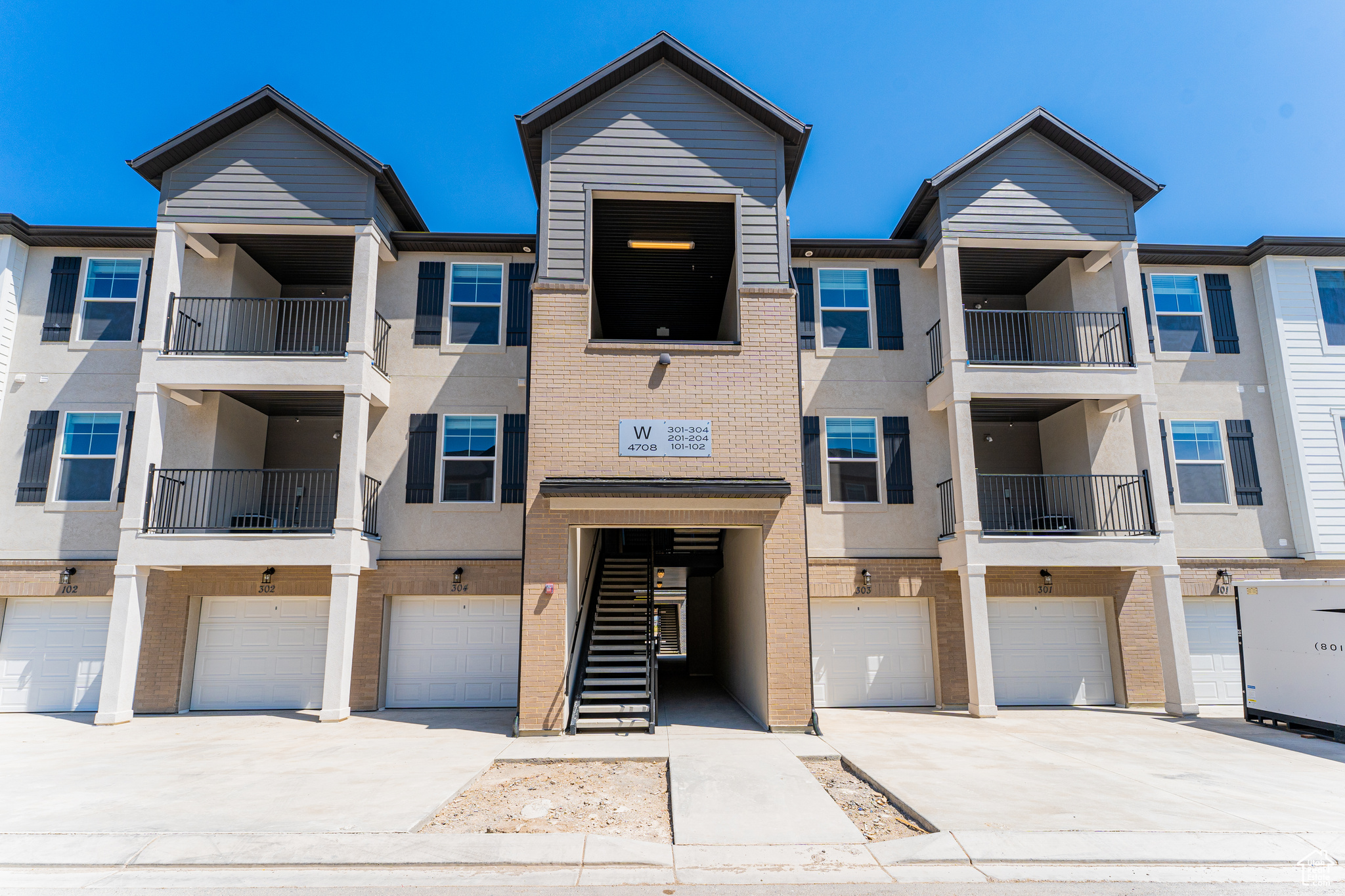 Townhome / multi-family property featuring a garage and a balcony