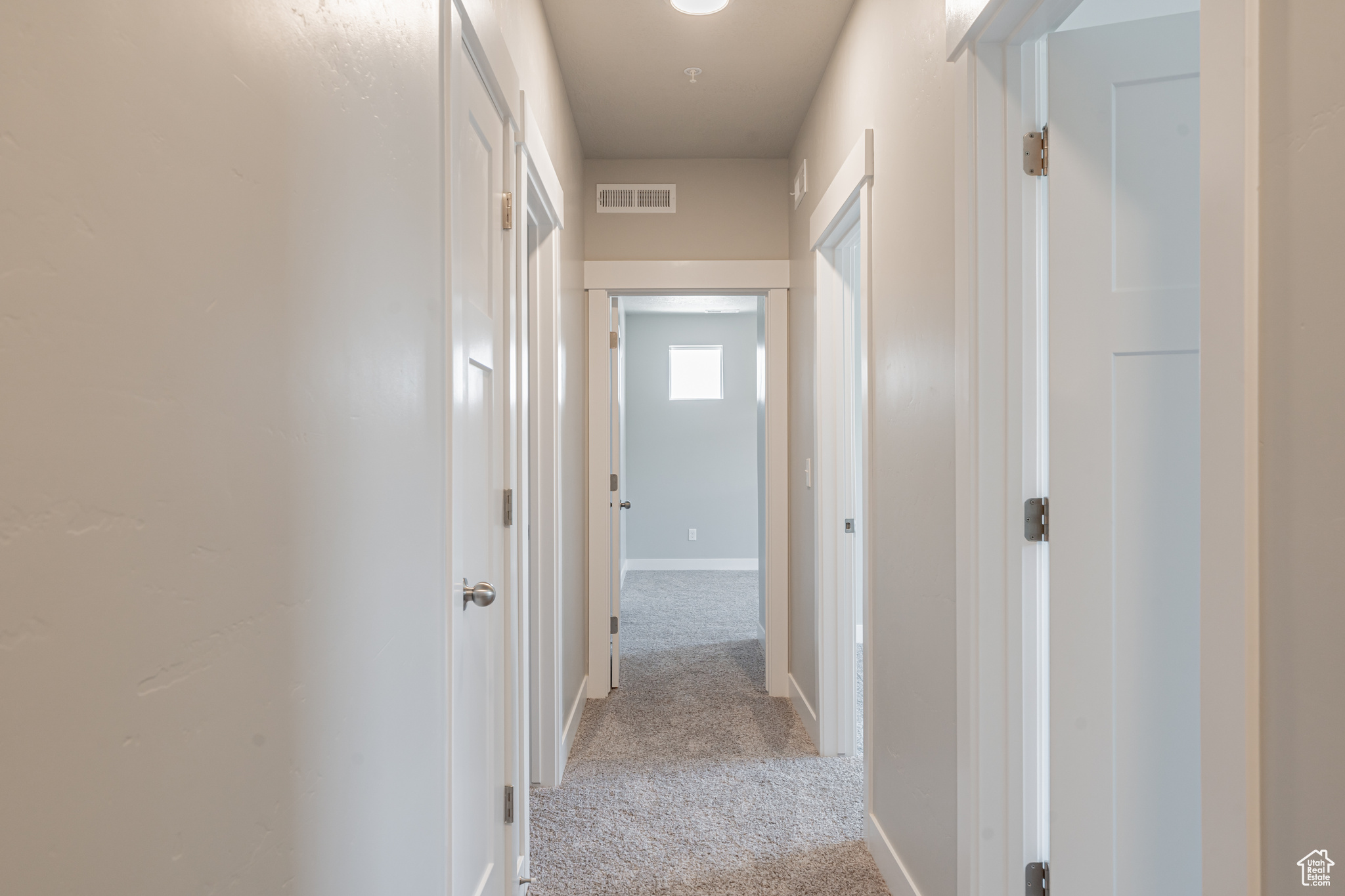 Hallway with light carpet