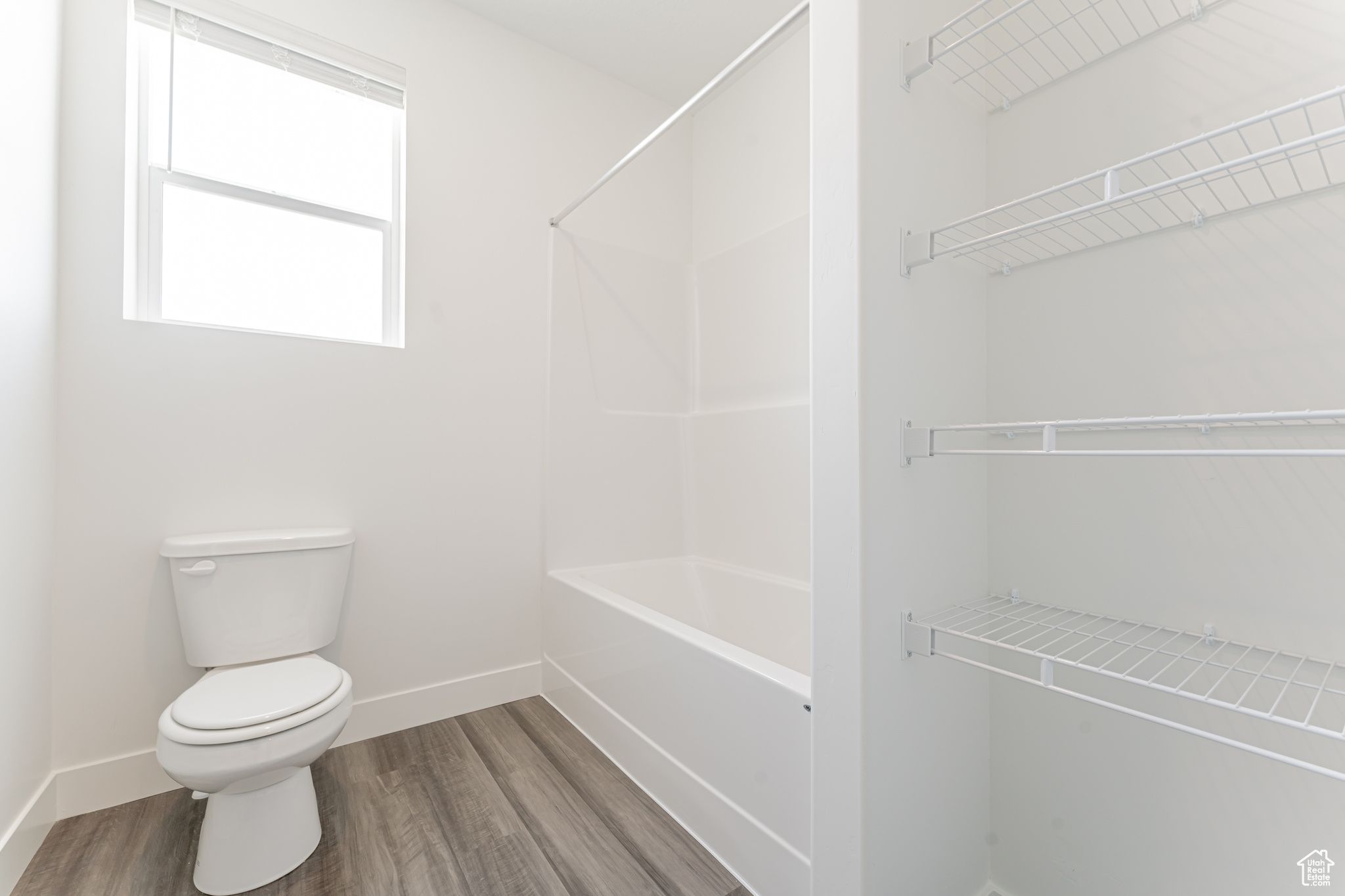 Bathroom featuring toilet and hardwood / wood-style flooring