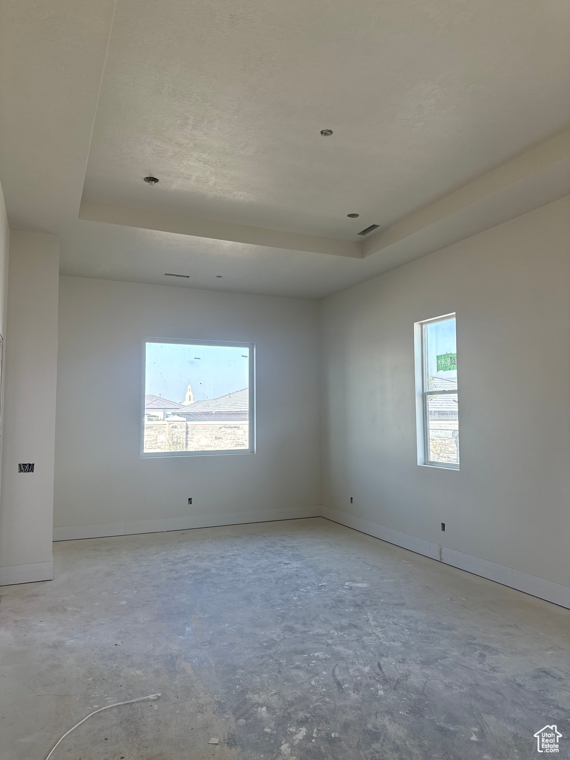 Empty room featuring a raised ceiling