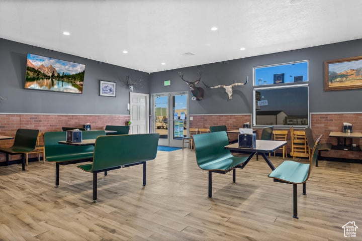 Game room with light hardwood / wood-style floors and french doors