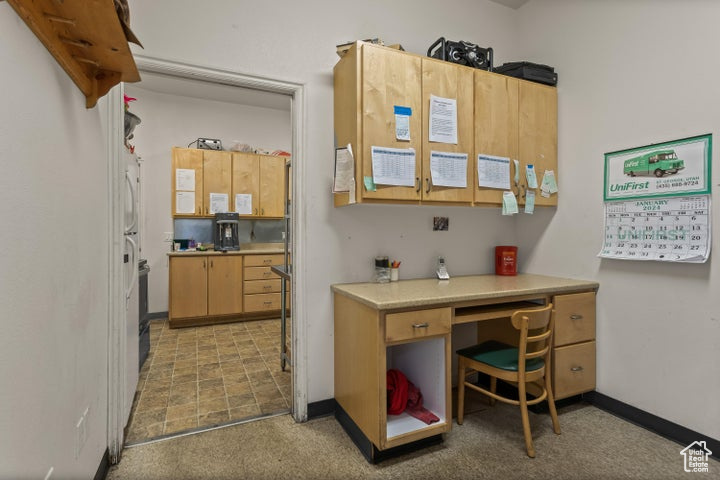 Kitchen with light brown cabinets and light carpet