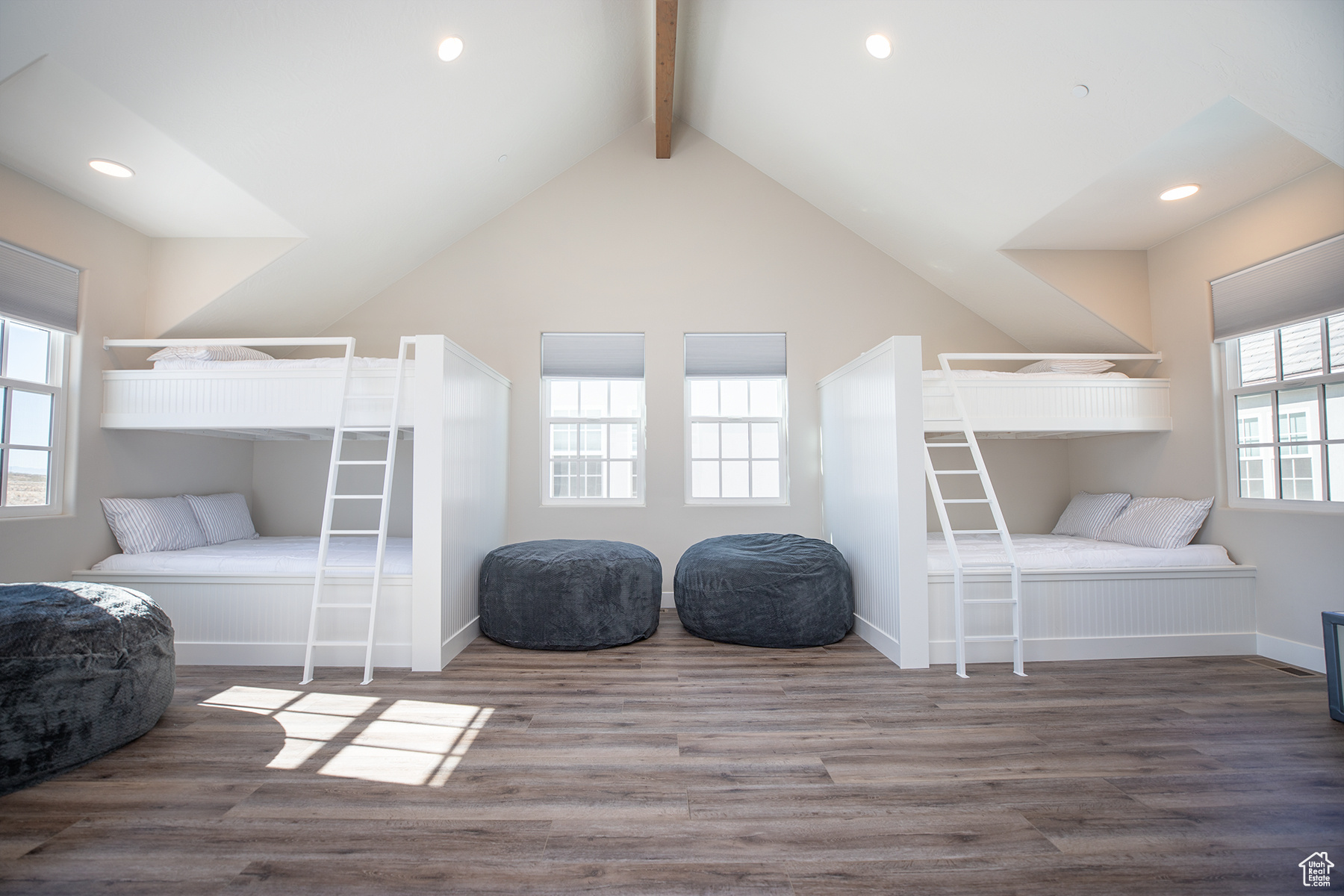 Bedroom with wood-type flooring and vaulted ceiling with beams