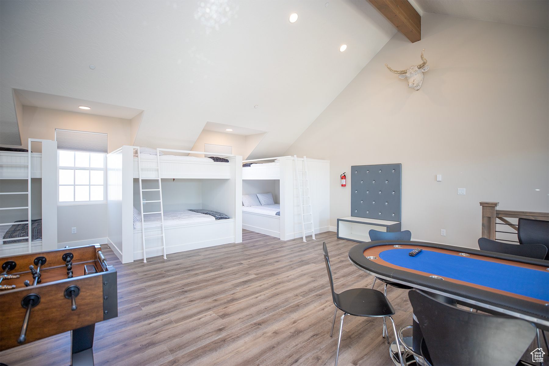 Game room featuring light hardwood / wood-style floors, beamed ceiling, and high vaulted ceiling