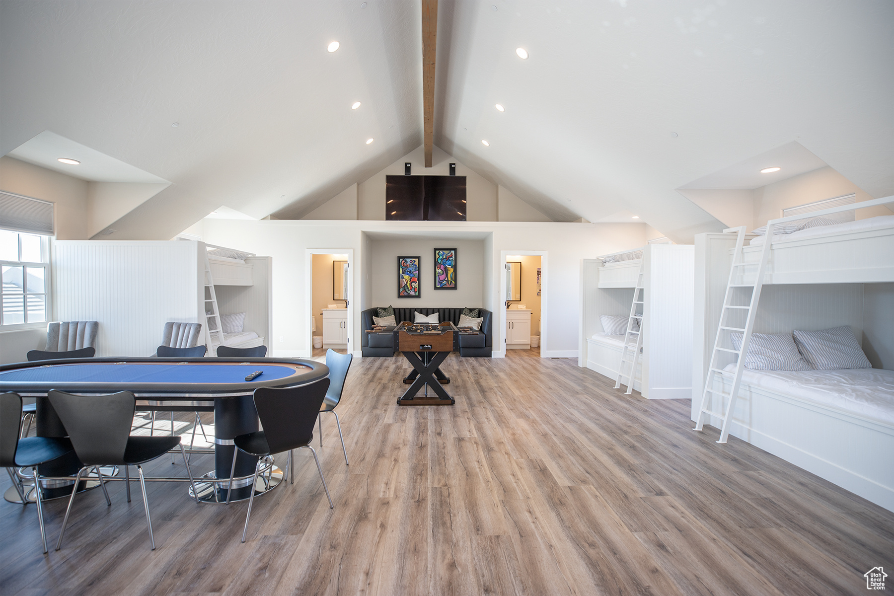 Rec room with light hardwood / wood-style floors, beamed ceiling, and high vaulted ceiling