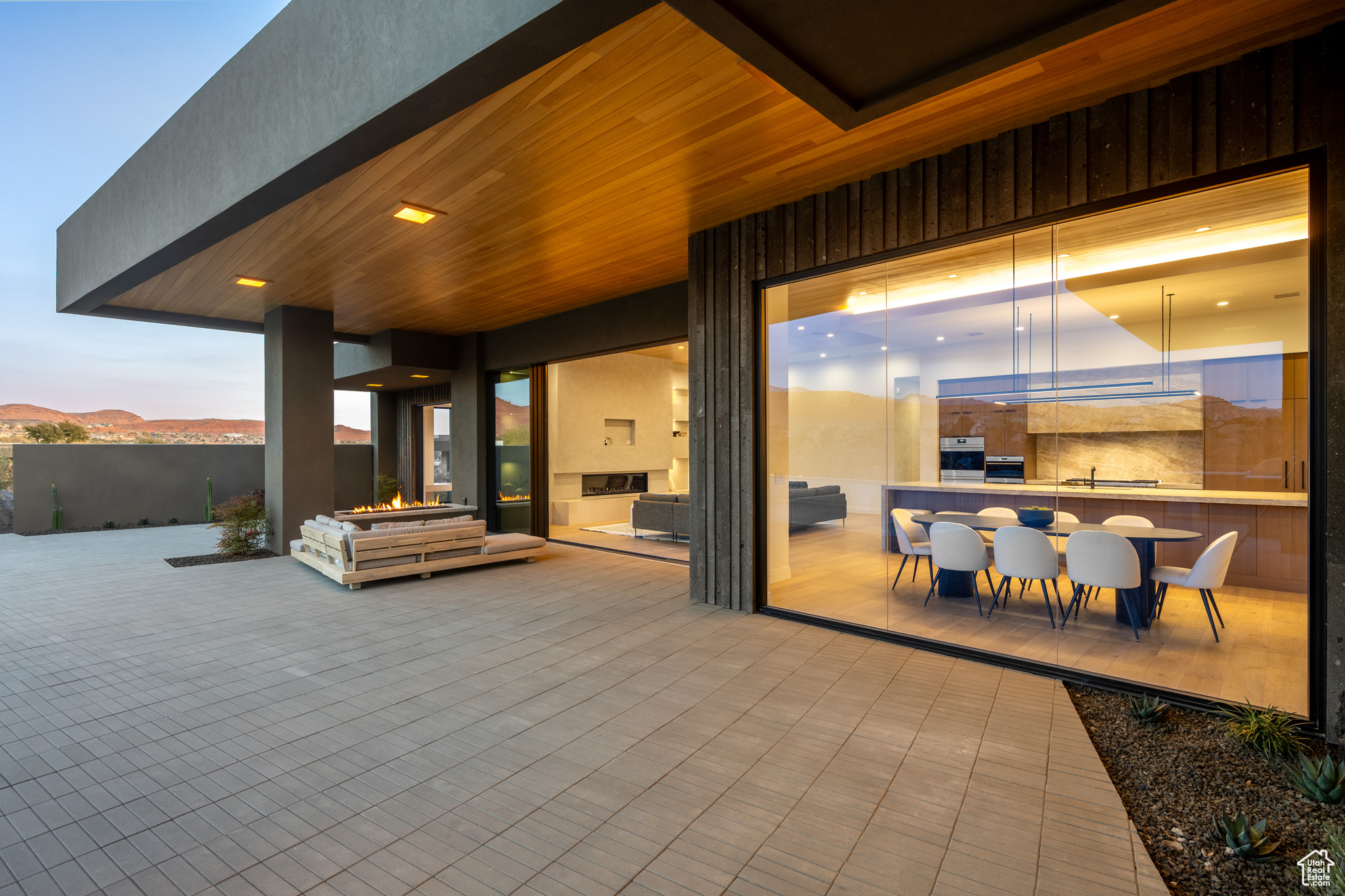 Patio terrace at dusk featuring a mountain view