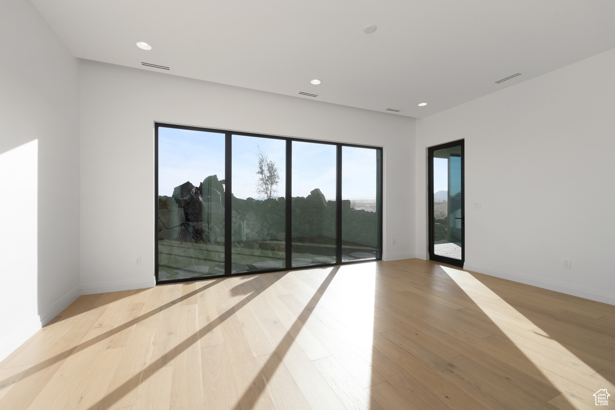 Spare room featuring light wood-type flooring