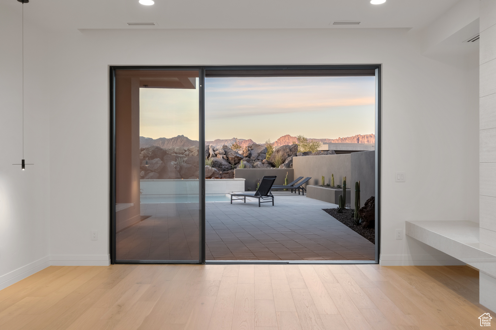 Doorway featuring a mountain view, light hardwood / wood-style floors, and a wealth of natural light