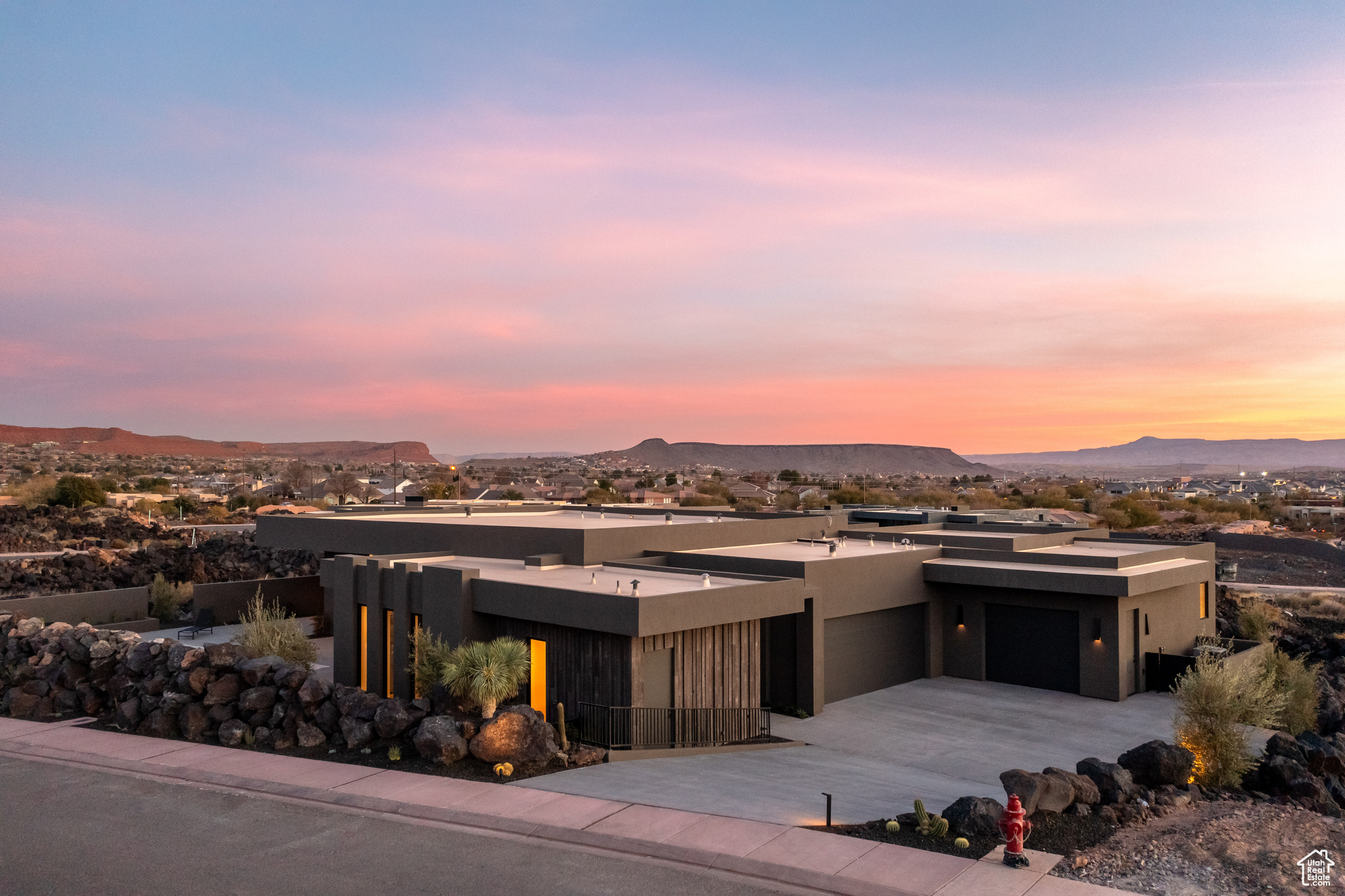 View of front of home with a mountain view and a garage