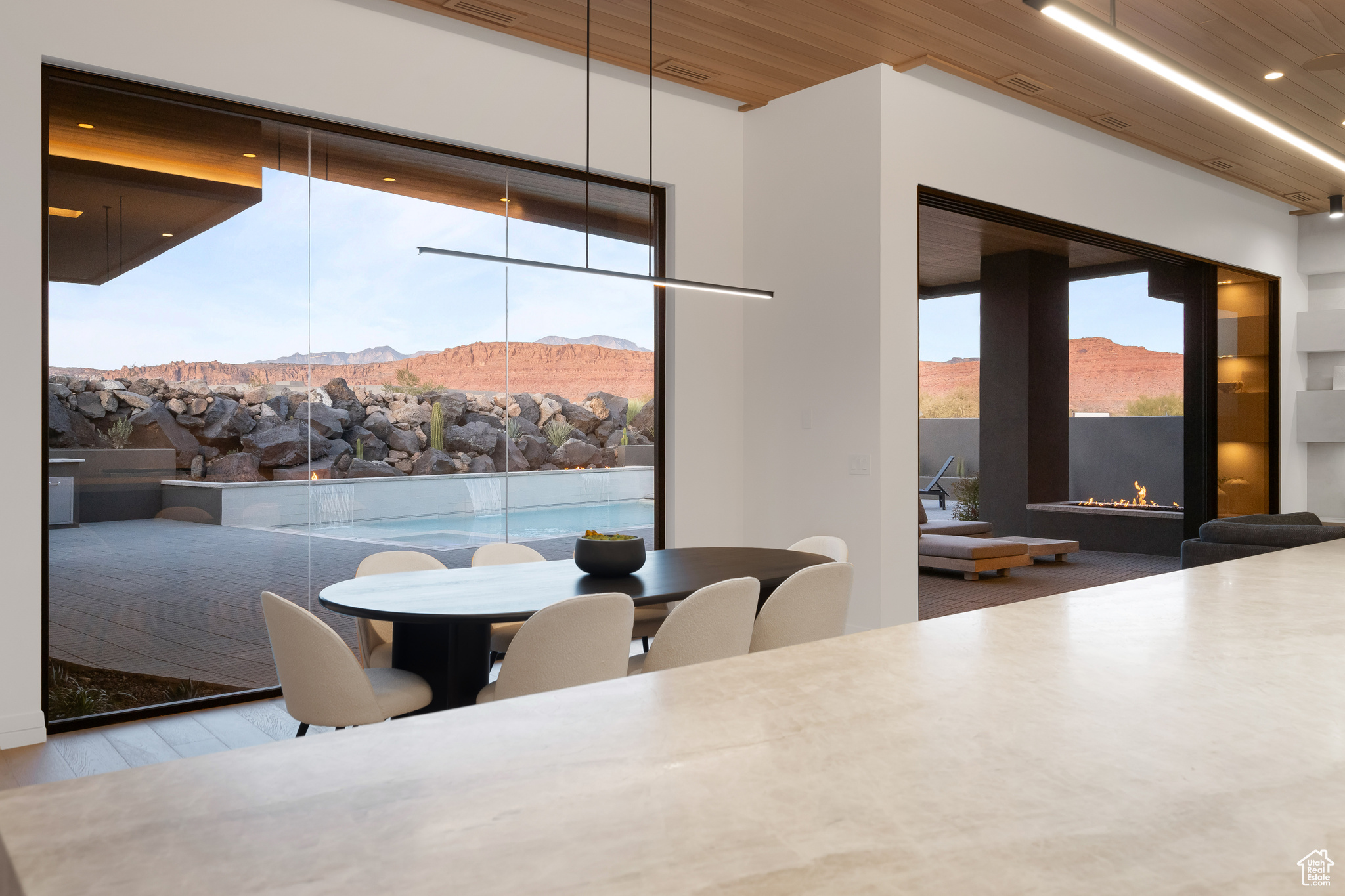 Dining space with a mountain view and wooden ceiling