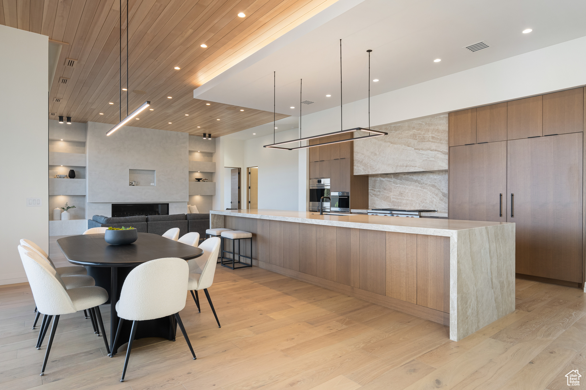 Kitchen with wooden ceiling, oven, light hardwood / wood-style floors, decorative light fixtures, and a fireplace