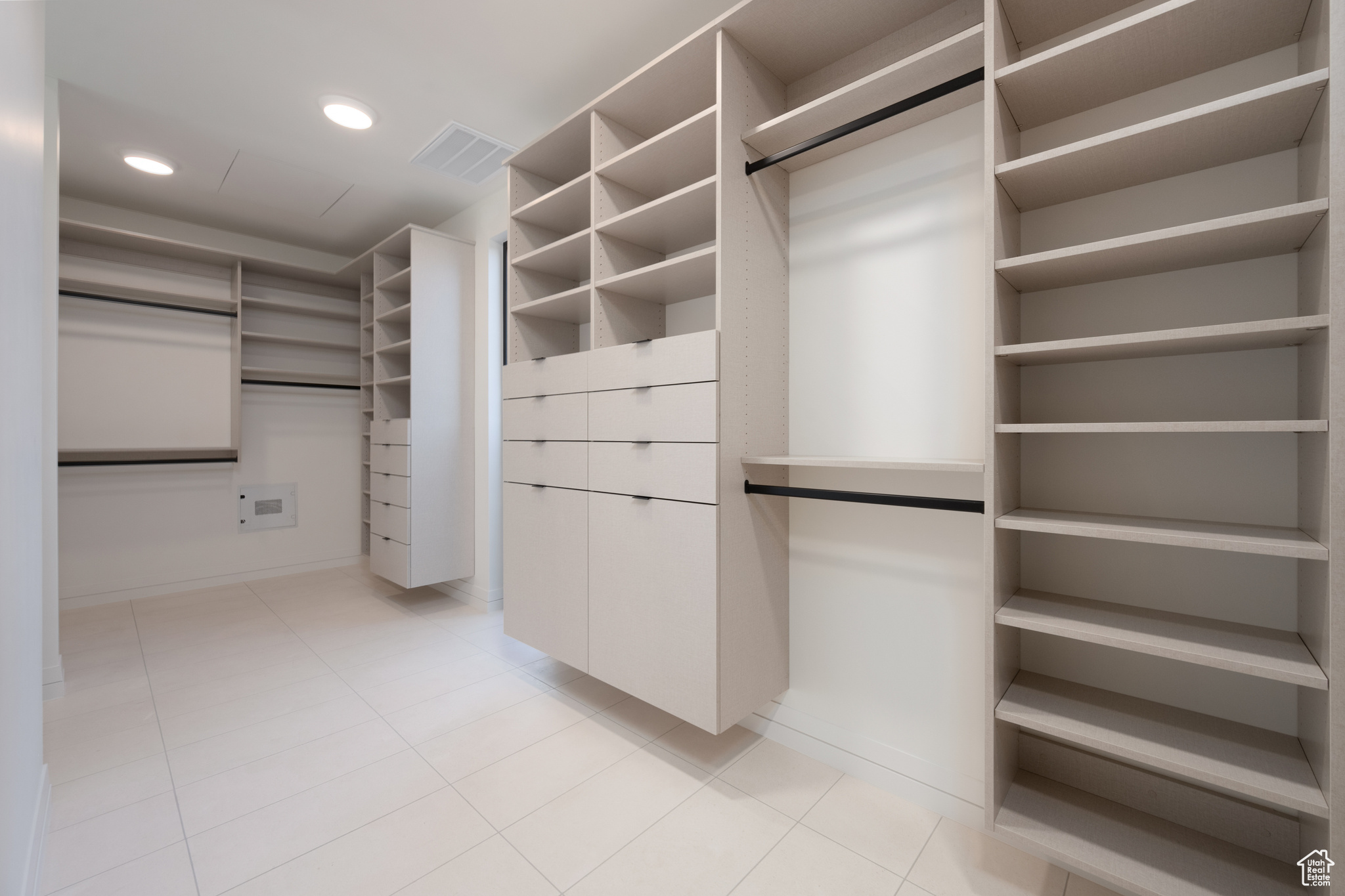 Spacious closet featuring light tile patterned floors