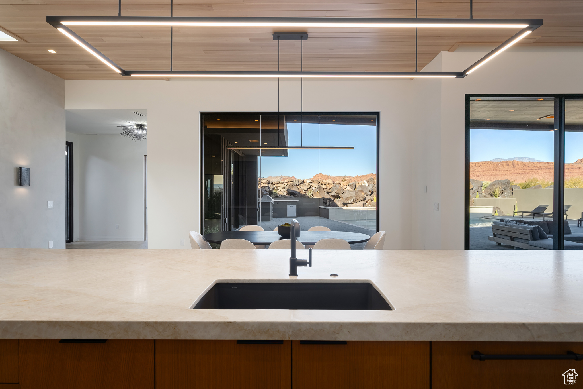 Kitchen featuring a mountain view, plenty of natural light, wooden ceiling, and sink