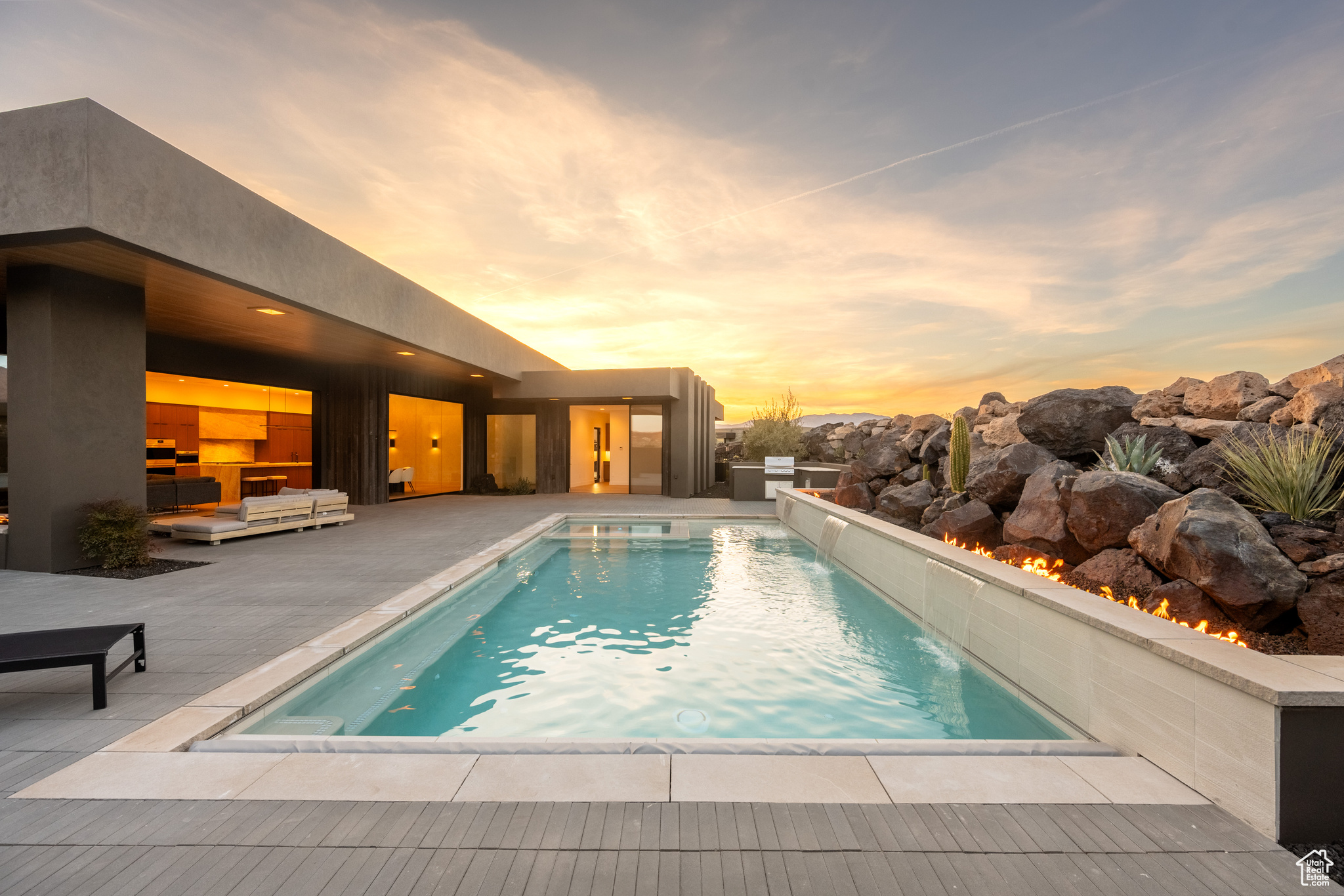 Pool at dusk with a patio area