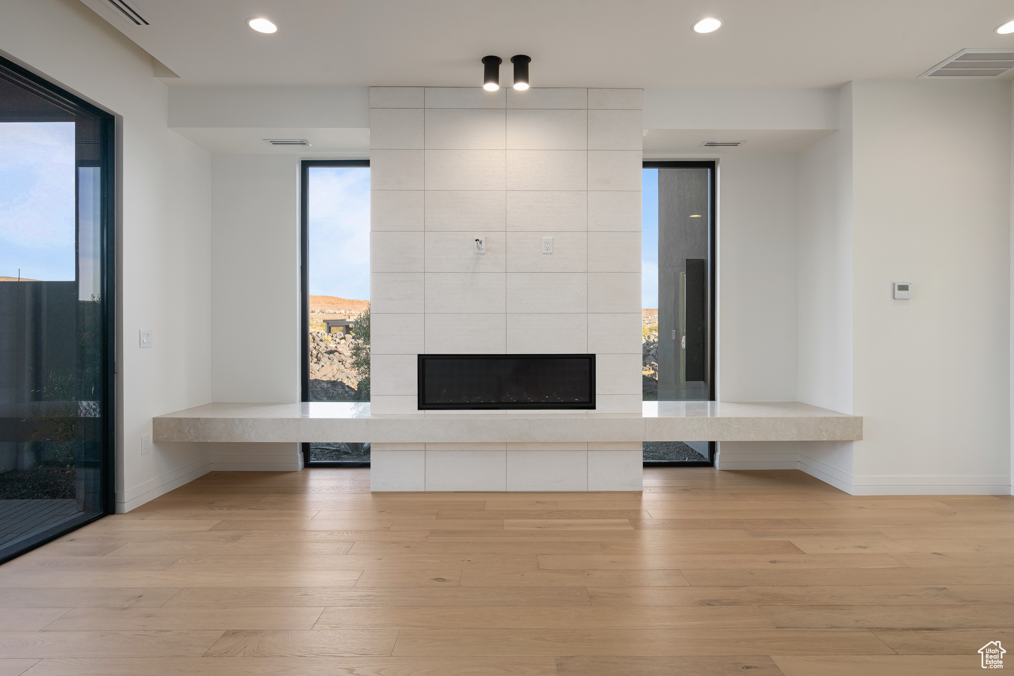 Unfurnished living room with a fireplace and light wood-type flooring